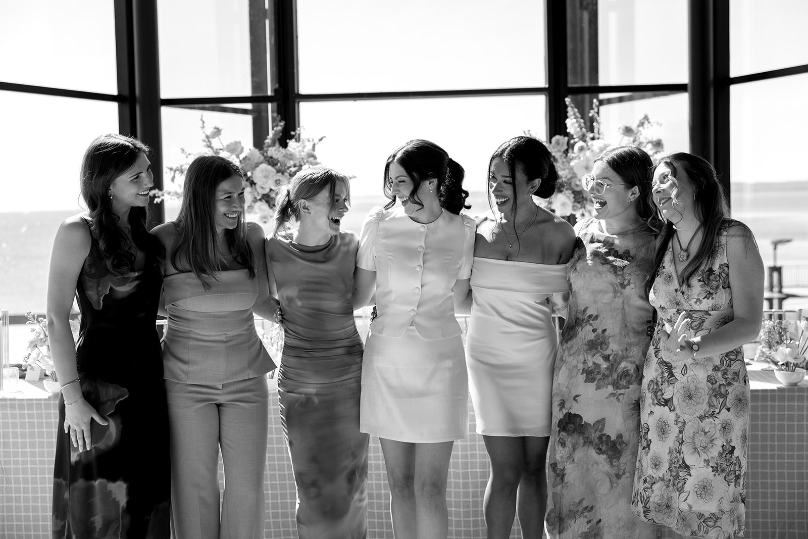  Bride and wedding party share a giggle with each other as guests arrive to shower the bride with love. 