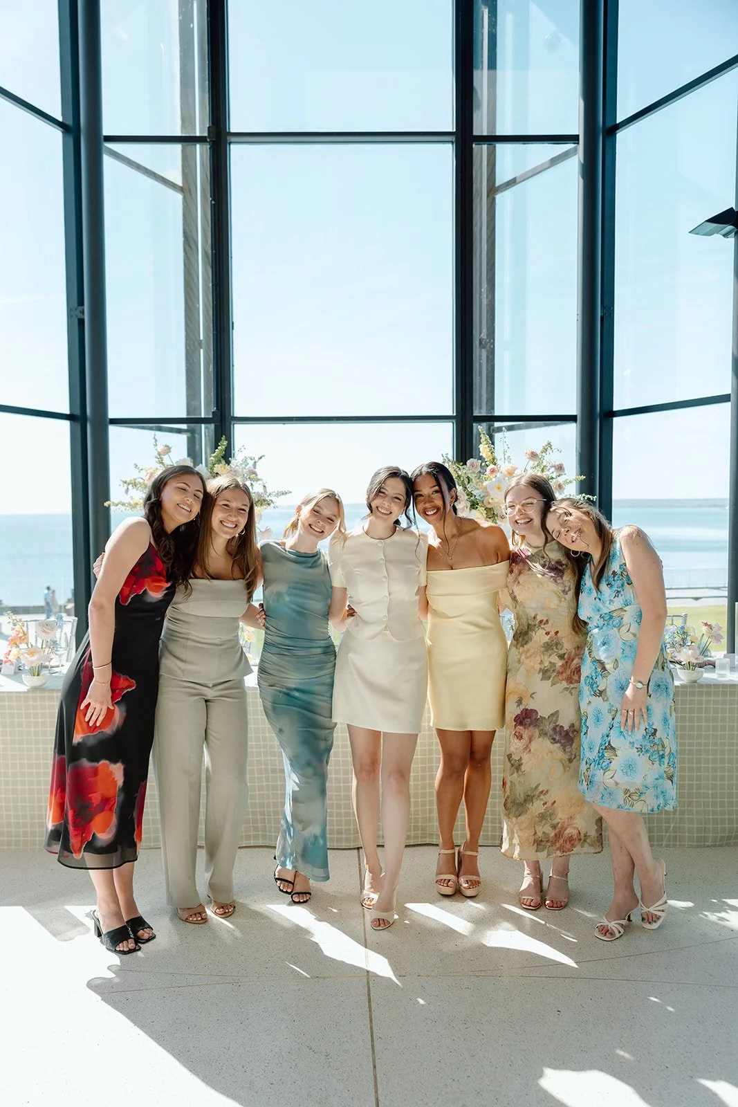  Wedding party and bride welcome guests to the bridal shower taking place at Spencer’s at the Waterfront. 