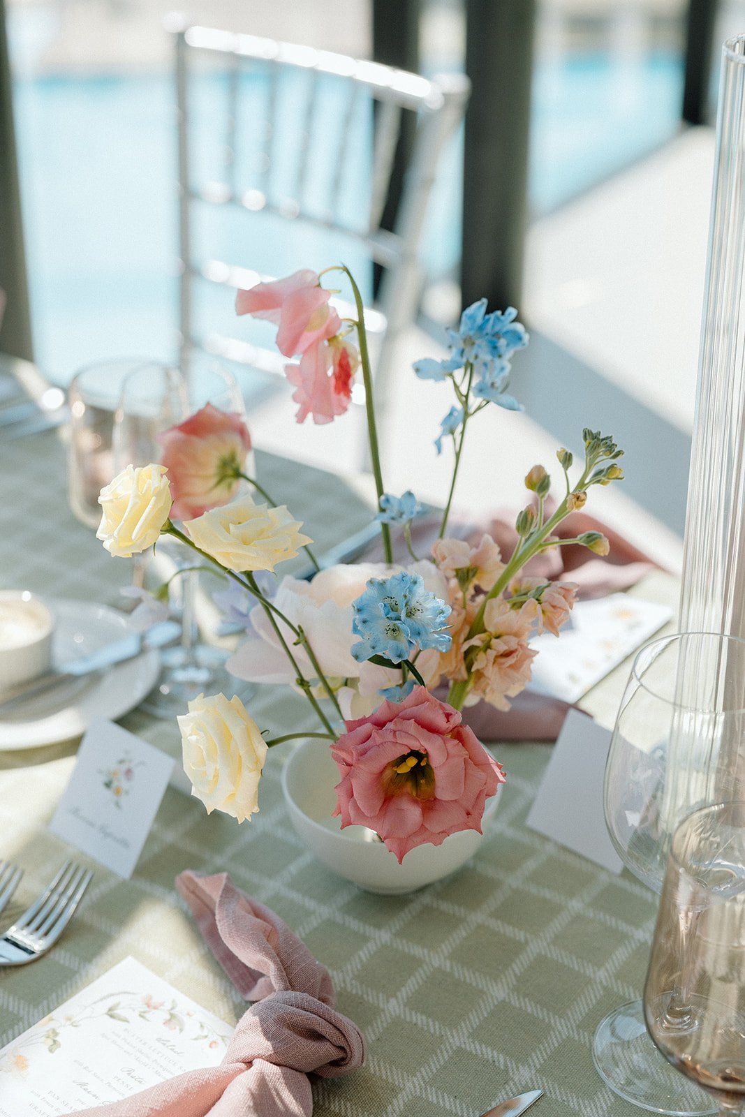  Small ikebana style vases bring the spring colour palette to life on these checkered patterned linens from Simply Beautiful Decor. 