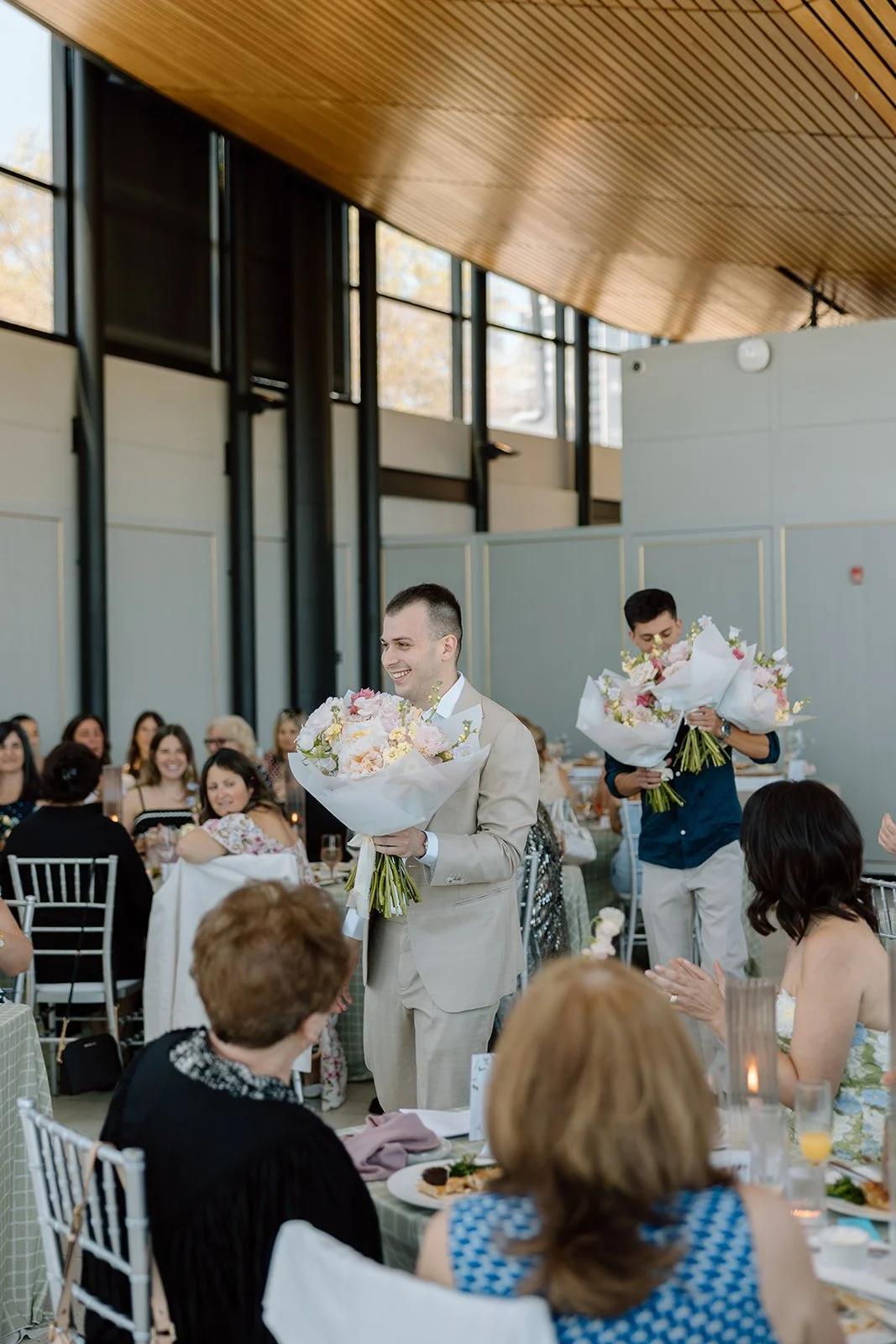  Groom and brother of the bride bring florals into the shower to give to members of the family. 