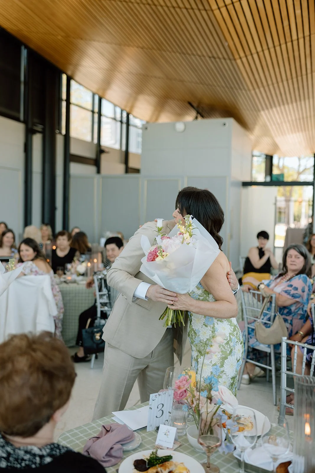 Grooms gives a floral bouquet to mother for bride. Florals by Simply Elegant by Emma. 