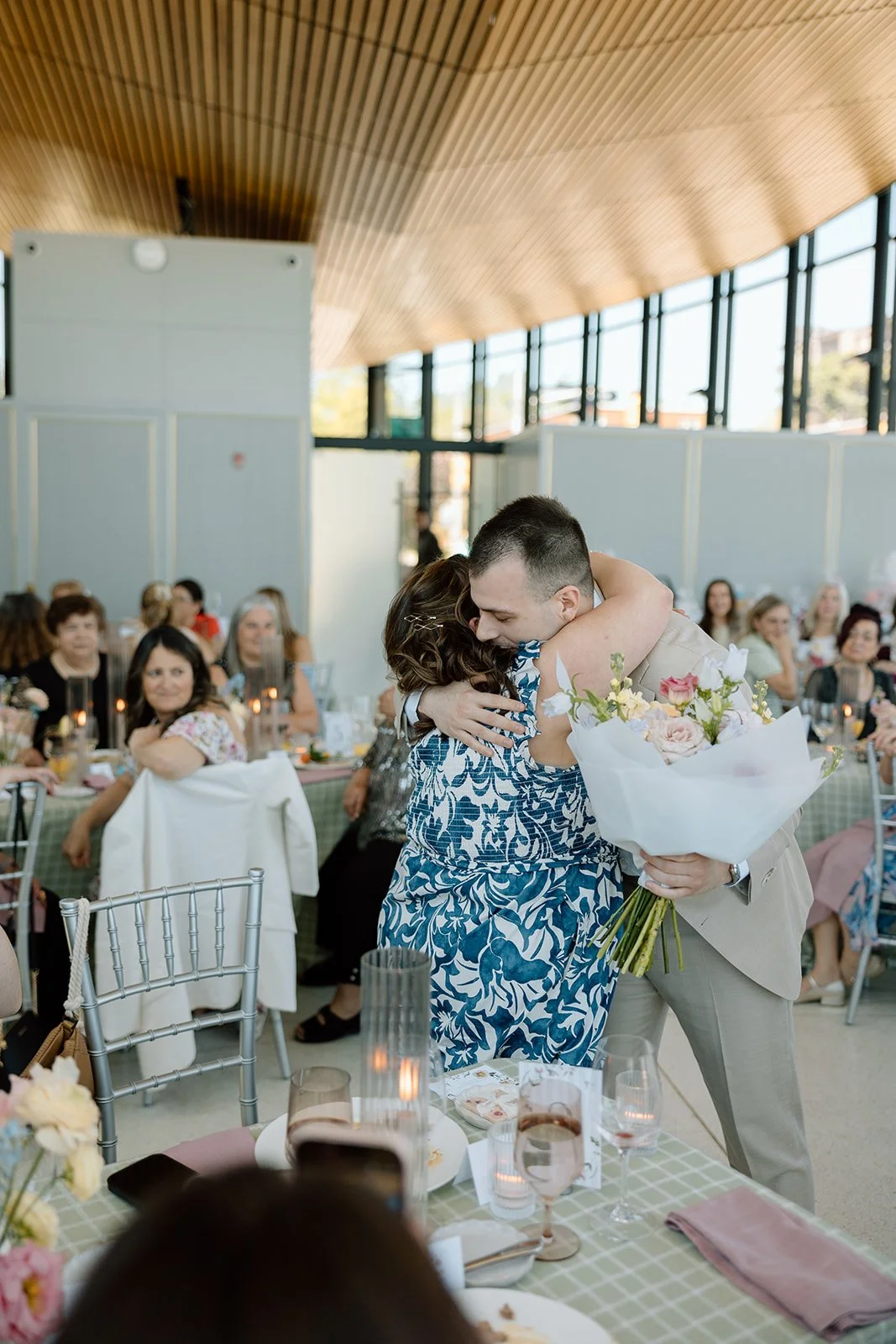  Grooms gives a floral bouquet to mother for groom. Florals by Simply Elegant by Emma. 