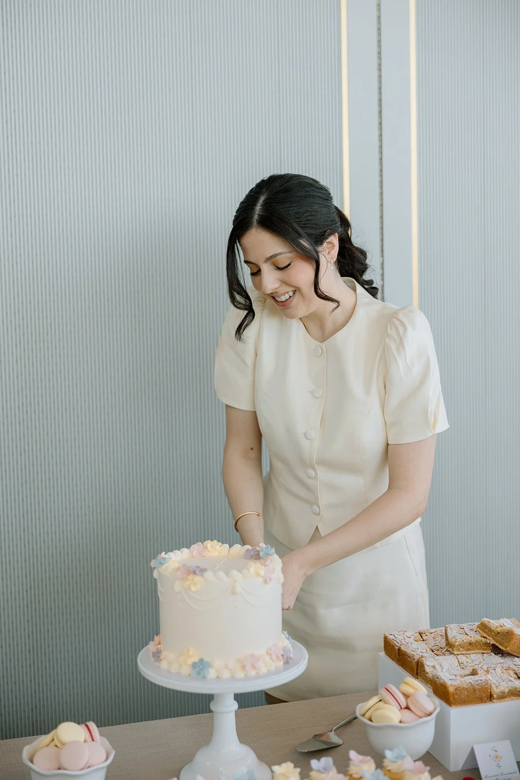  Bride cuts her small cutting cake at shower by The Dessert Room. 