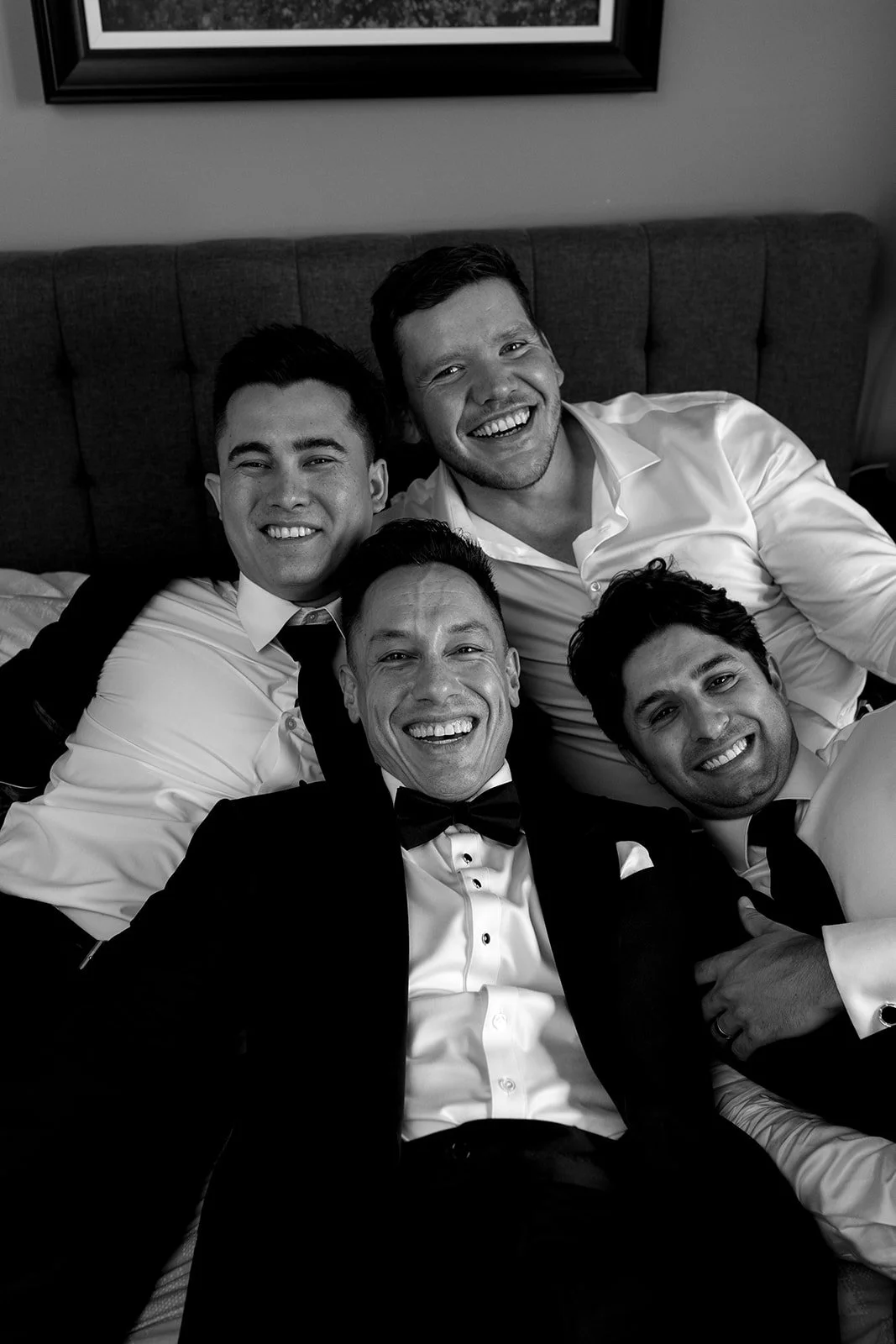  Groom and groomsmen share a laugh together during getting ready. 