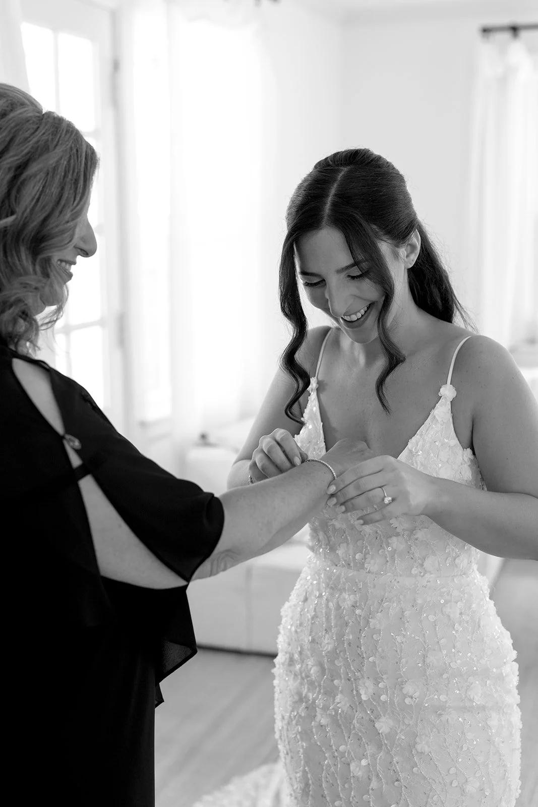 Mother and bride help each other dress before the ceremony. 