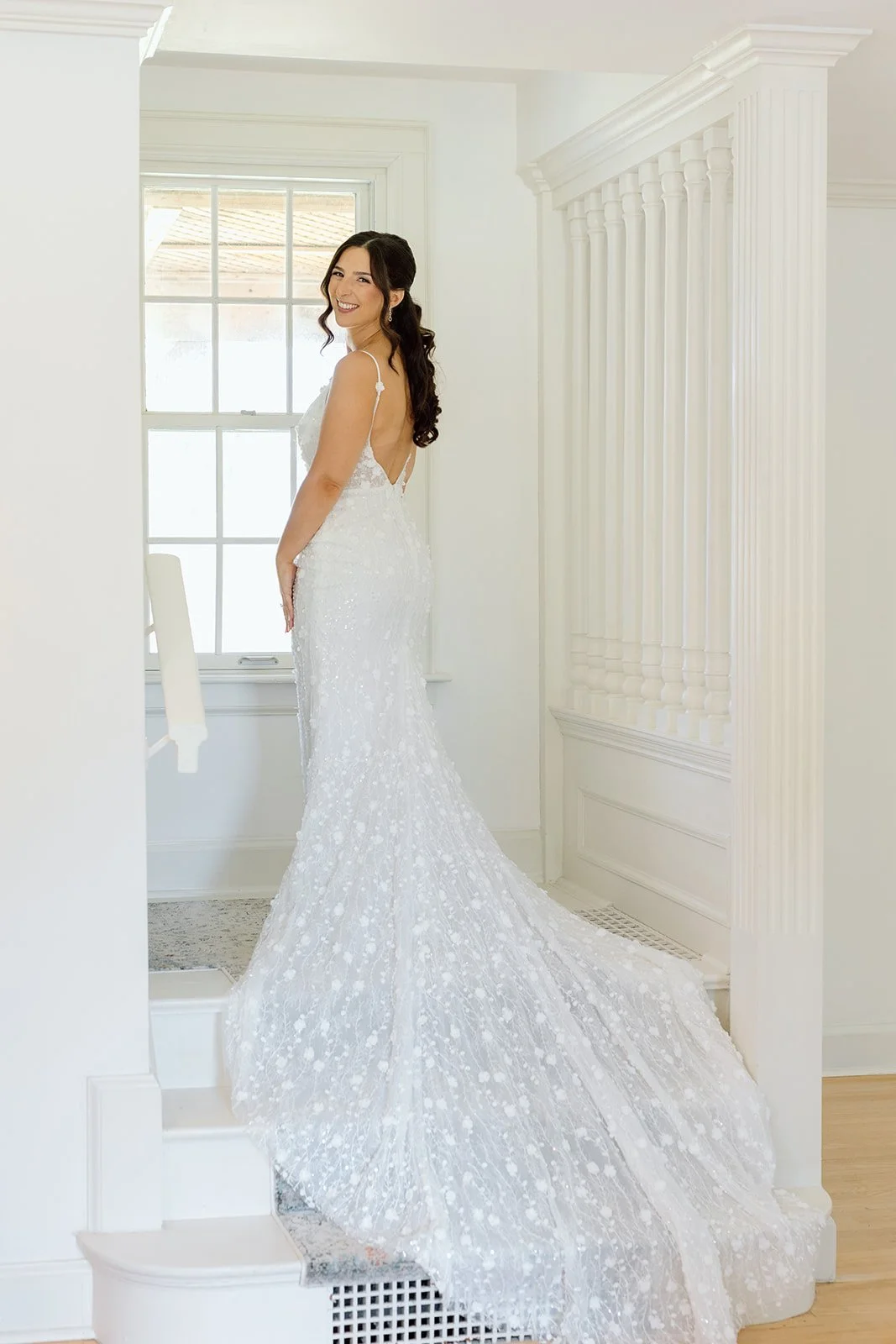  Floral patterned wedding gown cascades over the stairs at Willowfarm House NOTL, while the bride is getting ready. 