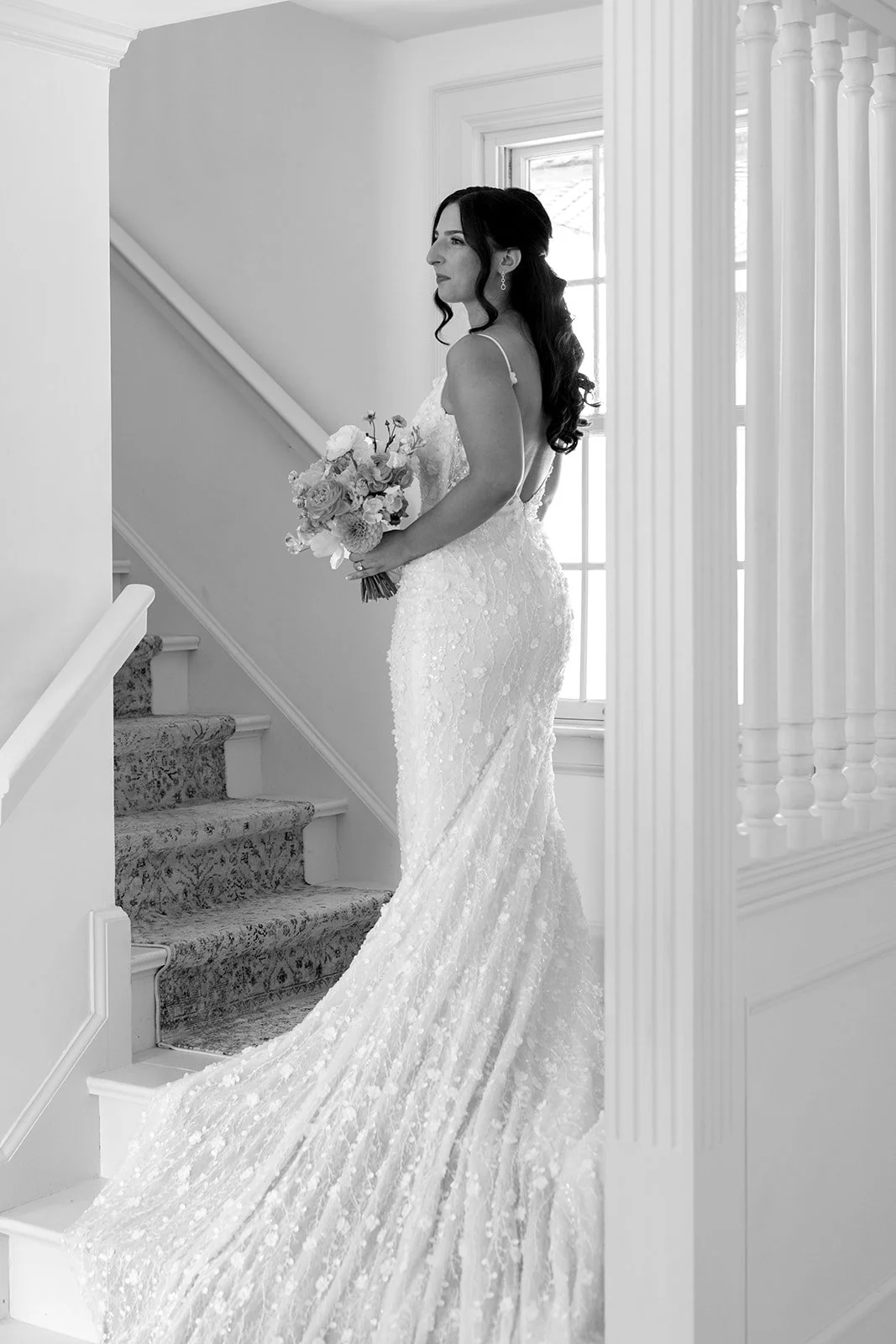  Classic black and white image of the bride on the staircase during her bridal portraits captured by Paula Visco Photography. 