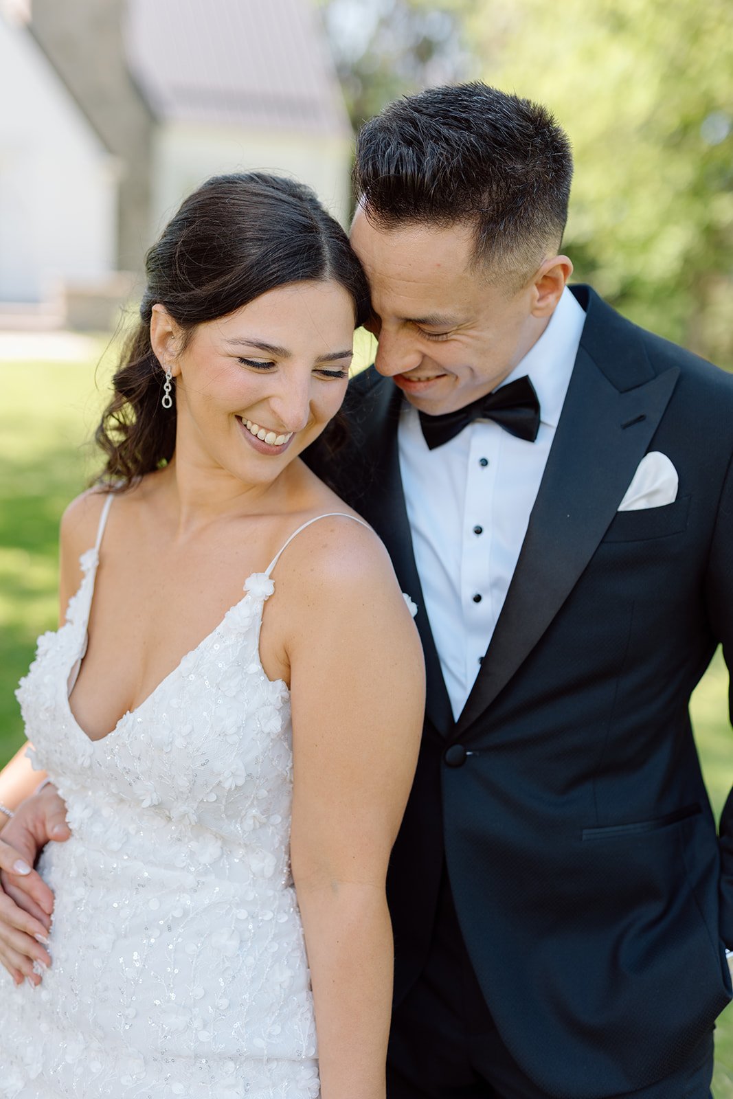  Intimate wedding vow exchange featuring a bride in an open-back wedding gown. 