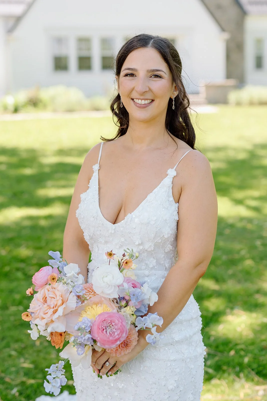  Candid black and white wedding photography of a bride holding a colorful pastel bouquet. 
