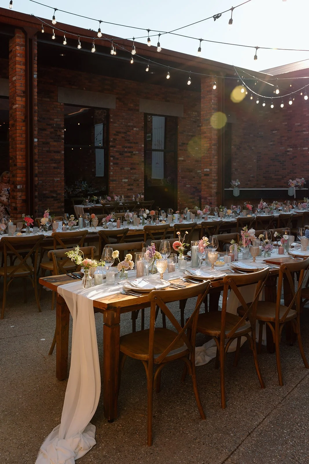  Modern vineyard wedding reception decor with wooden crossback chairs and chiffon runners. Reception held in the courtyard at The Hare Wine co. 