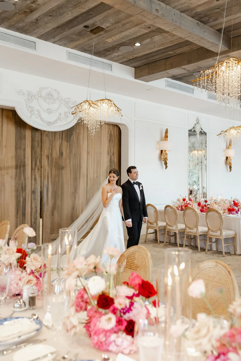 A bride and groom walk together on their wedding day at Elora Mill