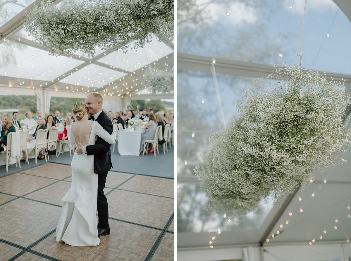 A large baby's breath hanging floral arrangement above a dance floor