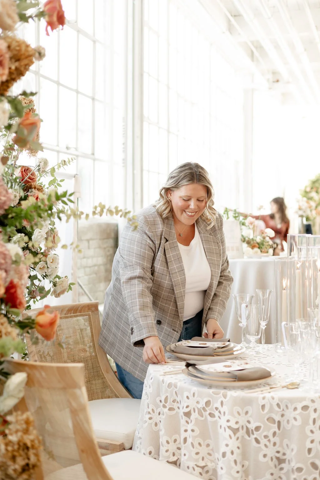 Lindsay Plank, a wedding planner at Lindsay Plank Events, stands behind her laptop while working on the duties and responsibilities of a wedding planner.