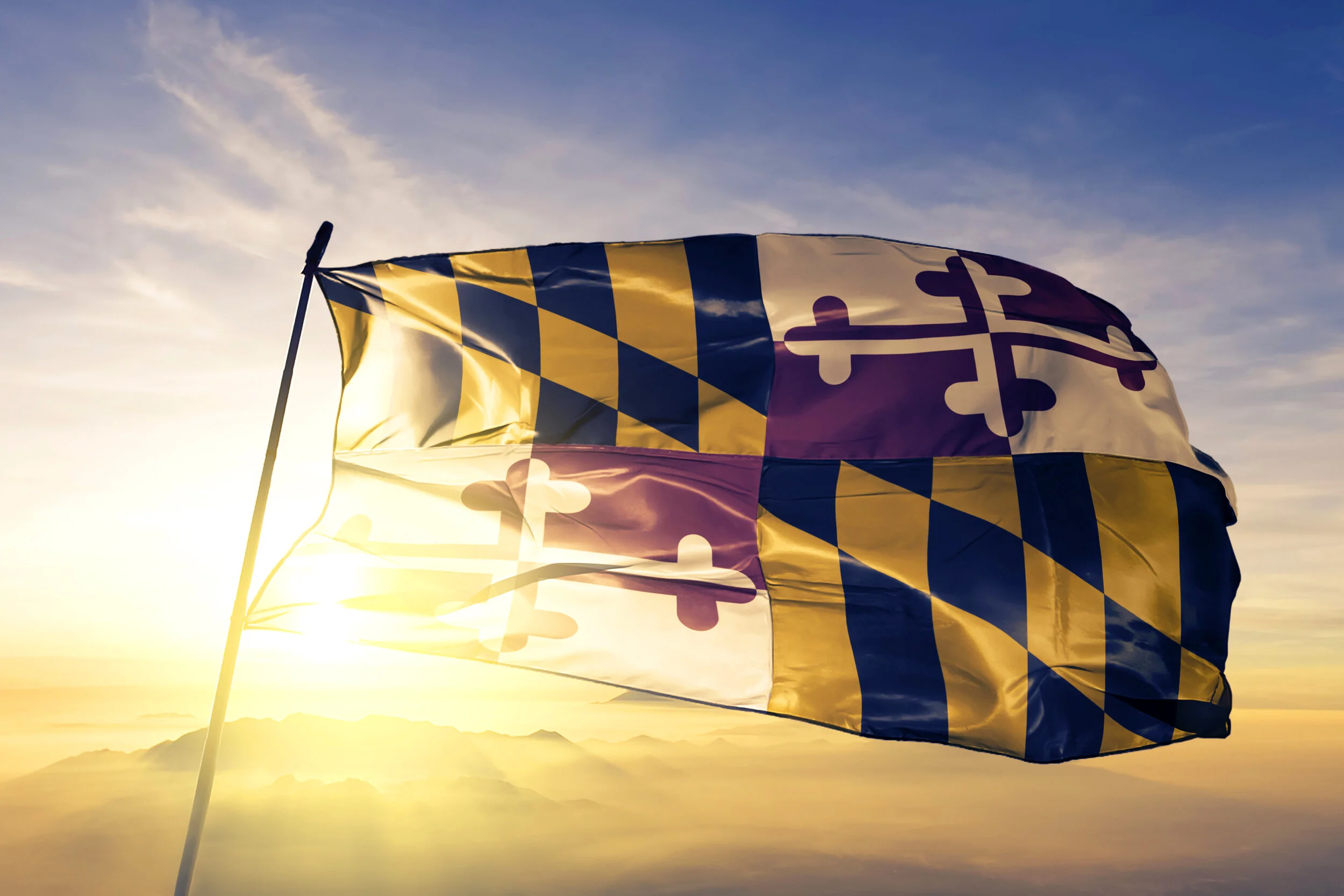 Maryland-state-of-United-States-flag-textile-cloth-fabric-waving-on-the-top-sunrise-mist-fog-1063332654_3660x2440.jpeg