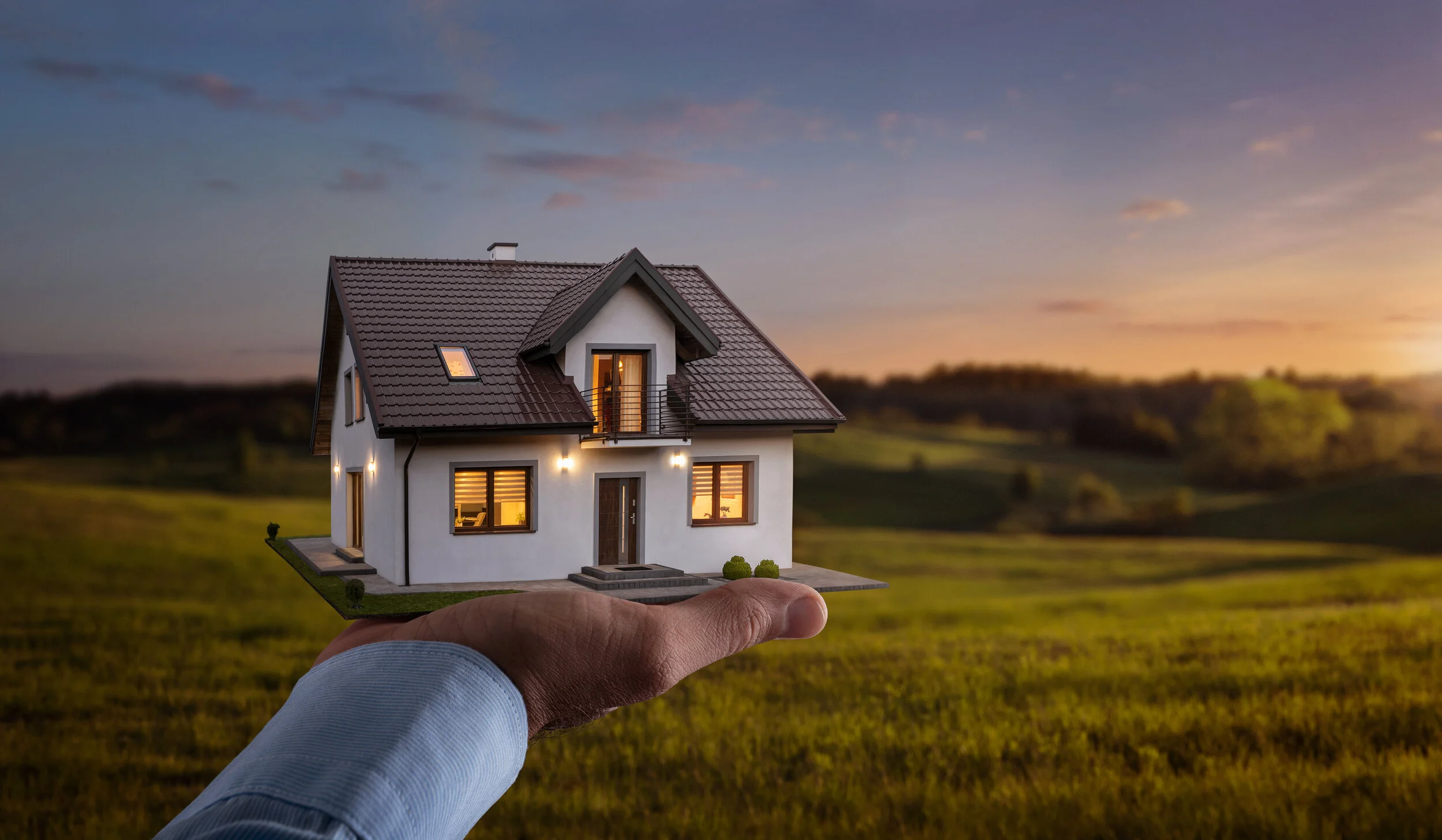 Male-hand-showing,-offering-a-new-dream-house-at-the-empty-field-with-copy-space-1205274326_6880x4010.jpeg