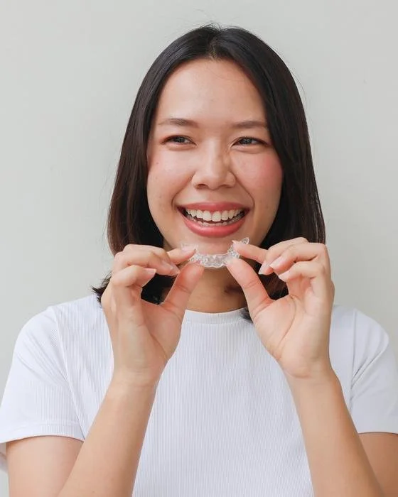 Adult smiling after treatment for teeth that shifted following braces at All Star Orthodontics in Richmond