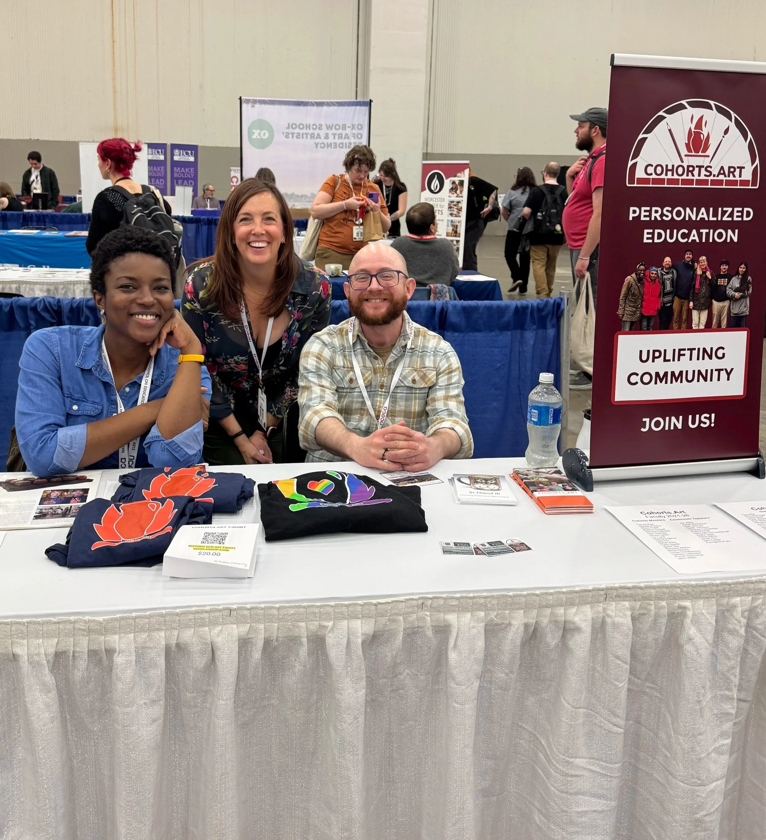Cohorts Alumni sharing their experience at the NCECA Resource Hall Table.