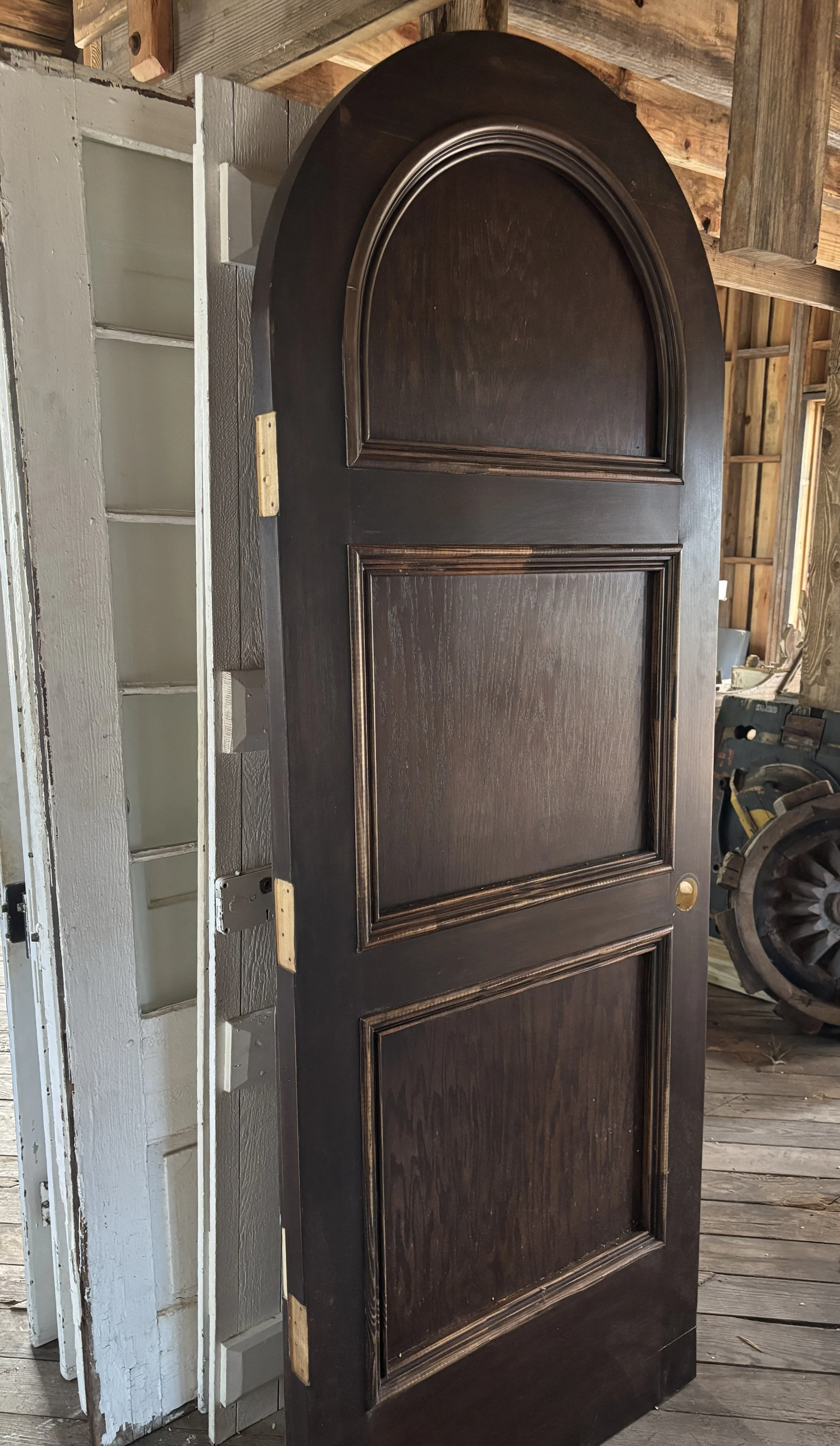 Arched wooden door with three trimmed panels, apprx 32 x 83 1/2 x 1 3/4.  Matching double doors for 48 x 83 opening,