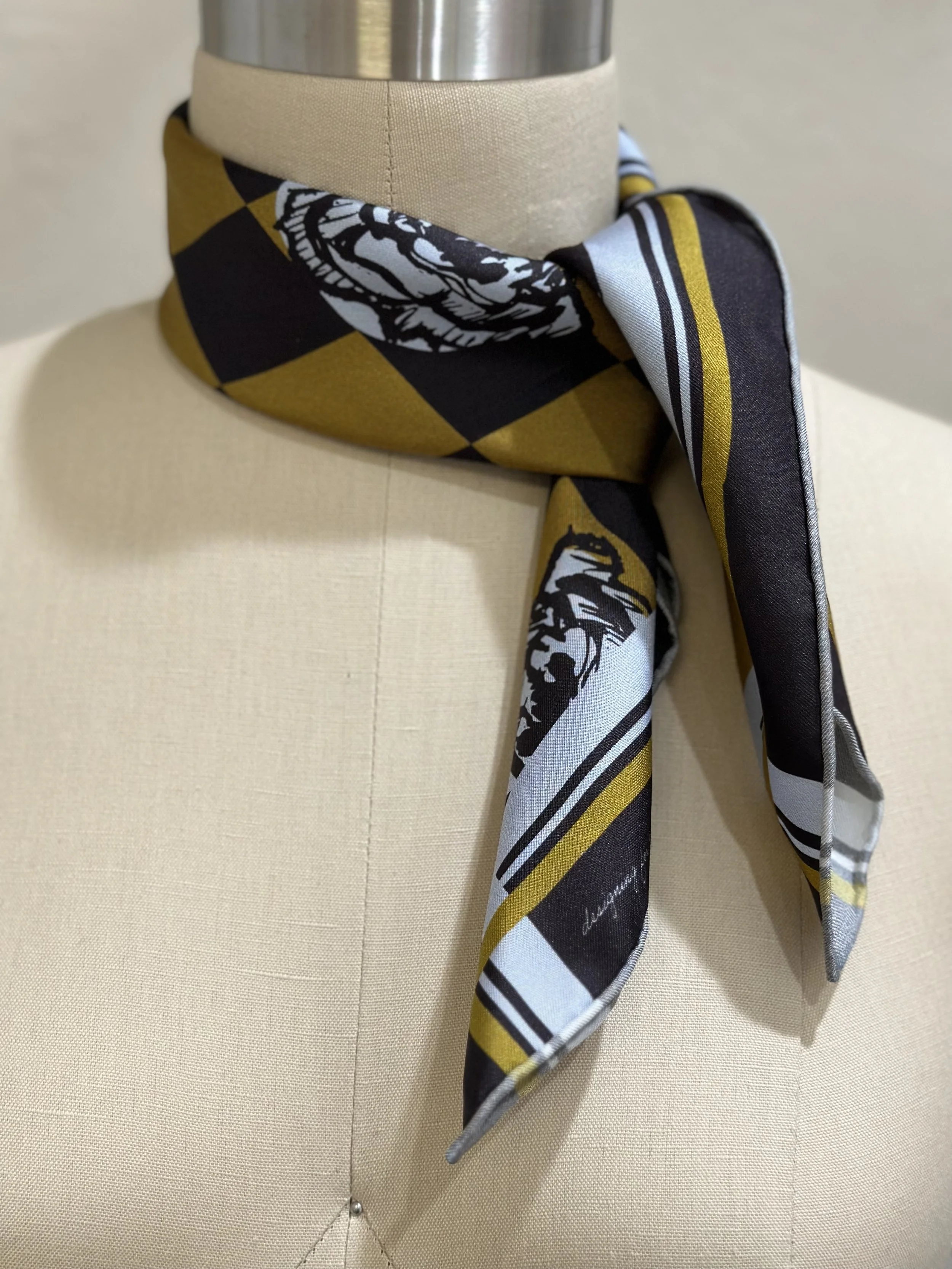 A gorgeously patterned 100% silk scarf, designed by Crisp Olive™ Studio. A checkered background of olive and black and light blue roses. A fashion statement to style up outfits instantly.