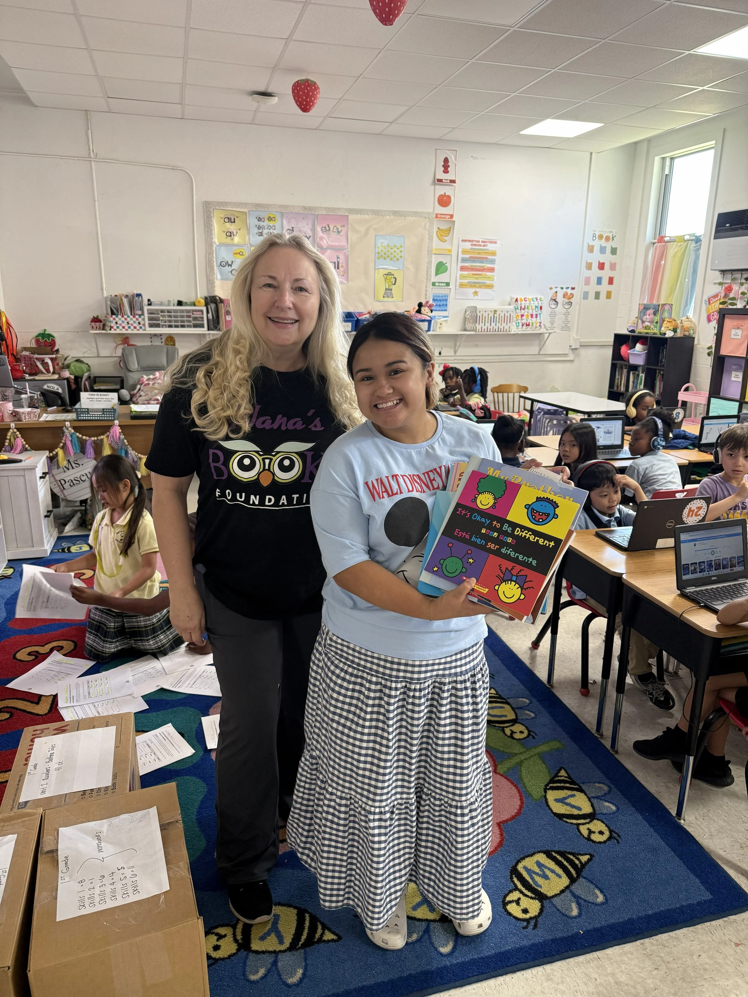 Nana’s Books Foundation representatives in a classroom holding the children’s book It’s Okay to Be Different.
