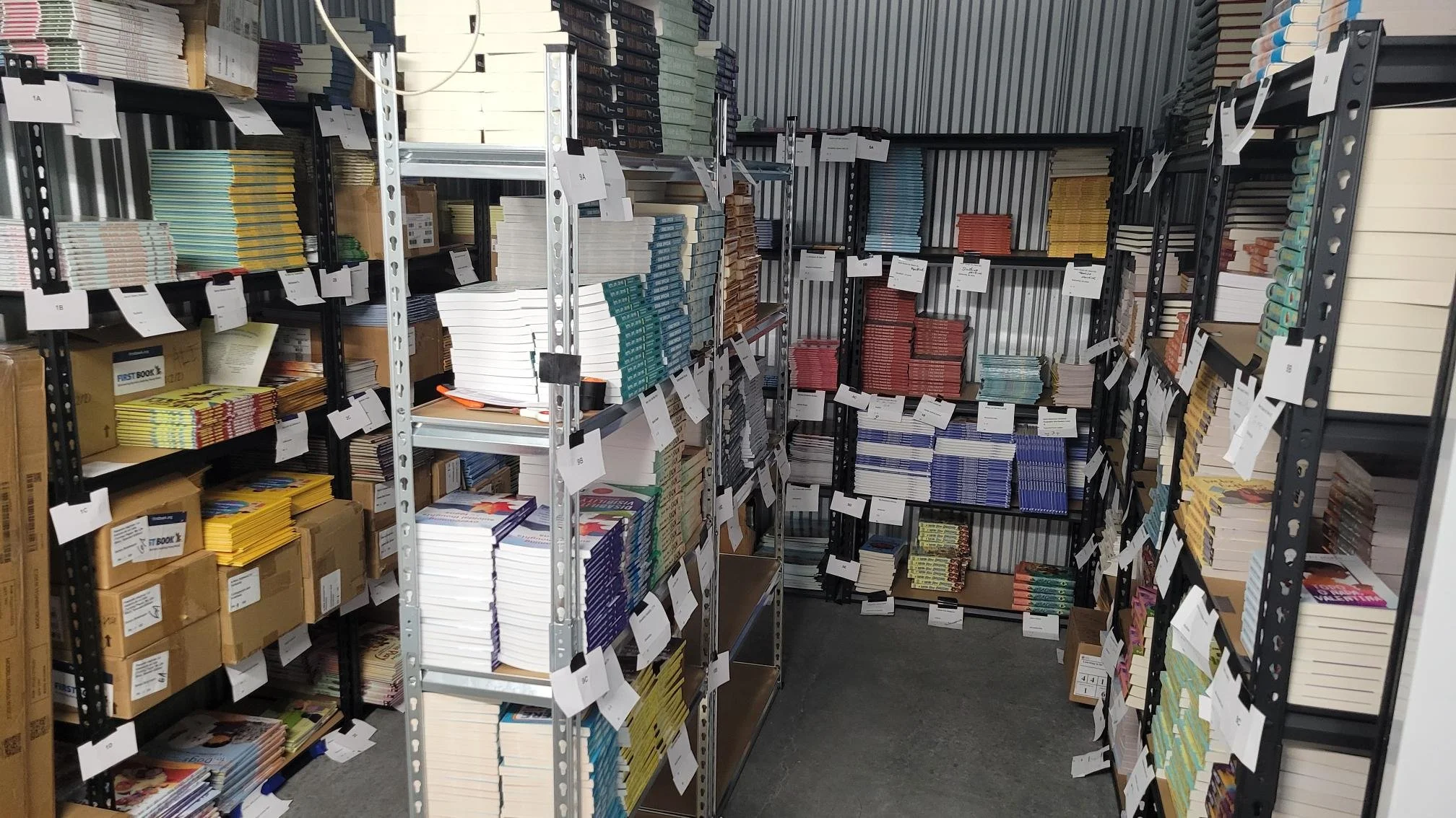 Shelves filled with organized children’s books awaiting distribution by Nana’s Books Foundation.