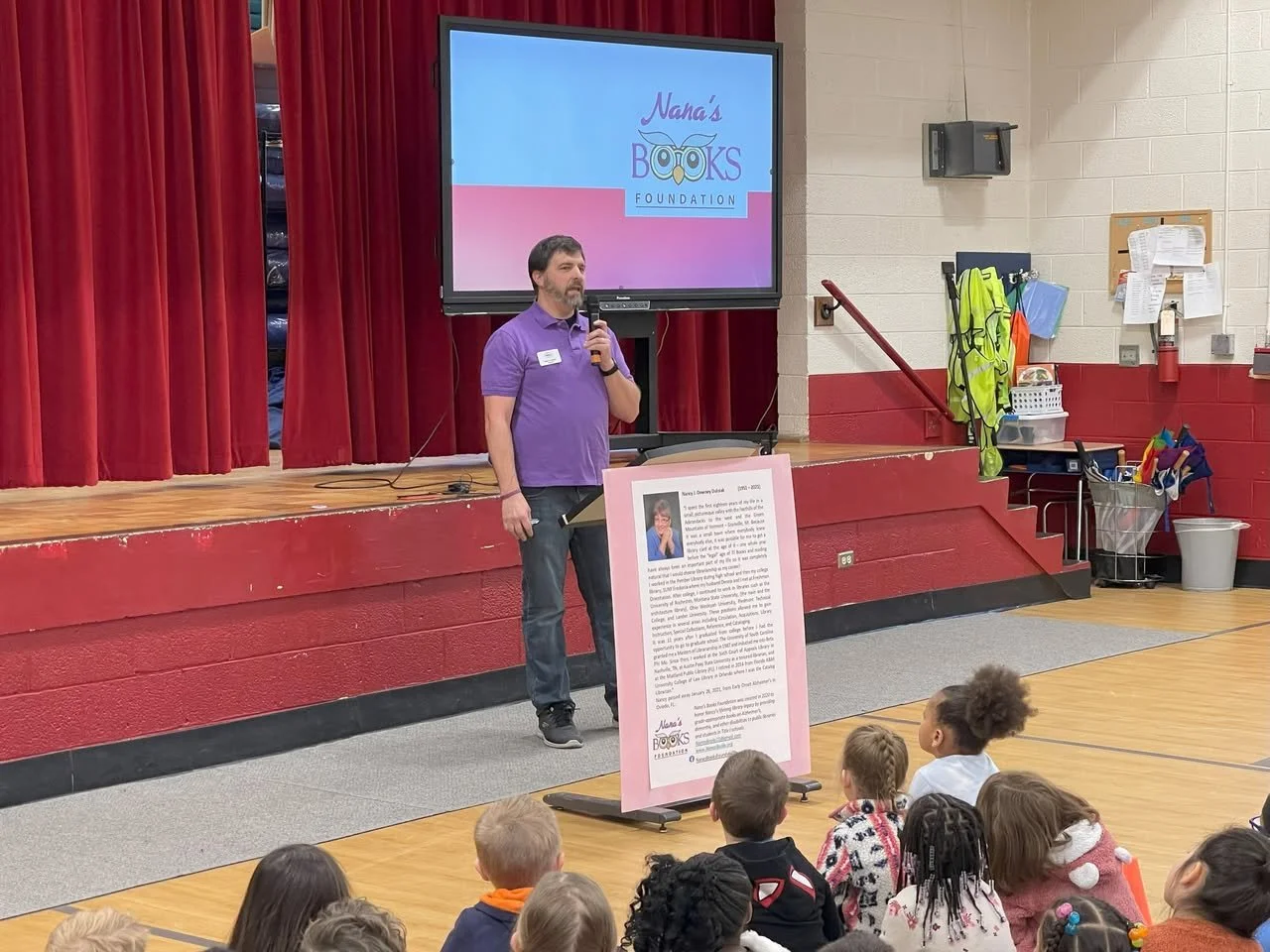 Mark Dulniak introduces Nana’s Books Foundation to students during an assembly at Mooreland Heights Elementary School in Knoxville, Tennessee.