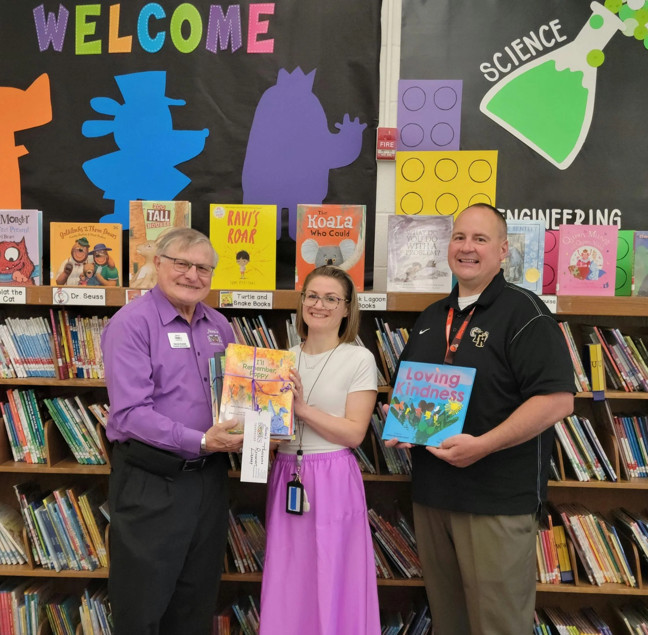 Dennis Dulniak with librarian Bill Wiesmore and principal Beth Zaccarine during Nana’s Books Foundation’s 2024 book distribution at Woodrow Wilson Elementary School in Sloan, New York.