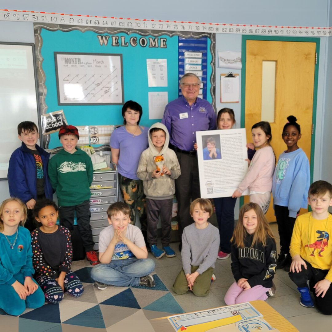 Dennis Dulniak with elementary school students during a Nana’s Books Foundation book presentation.