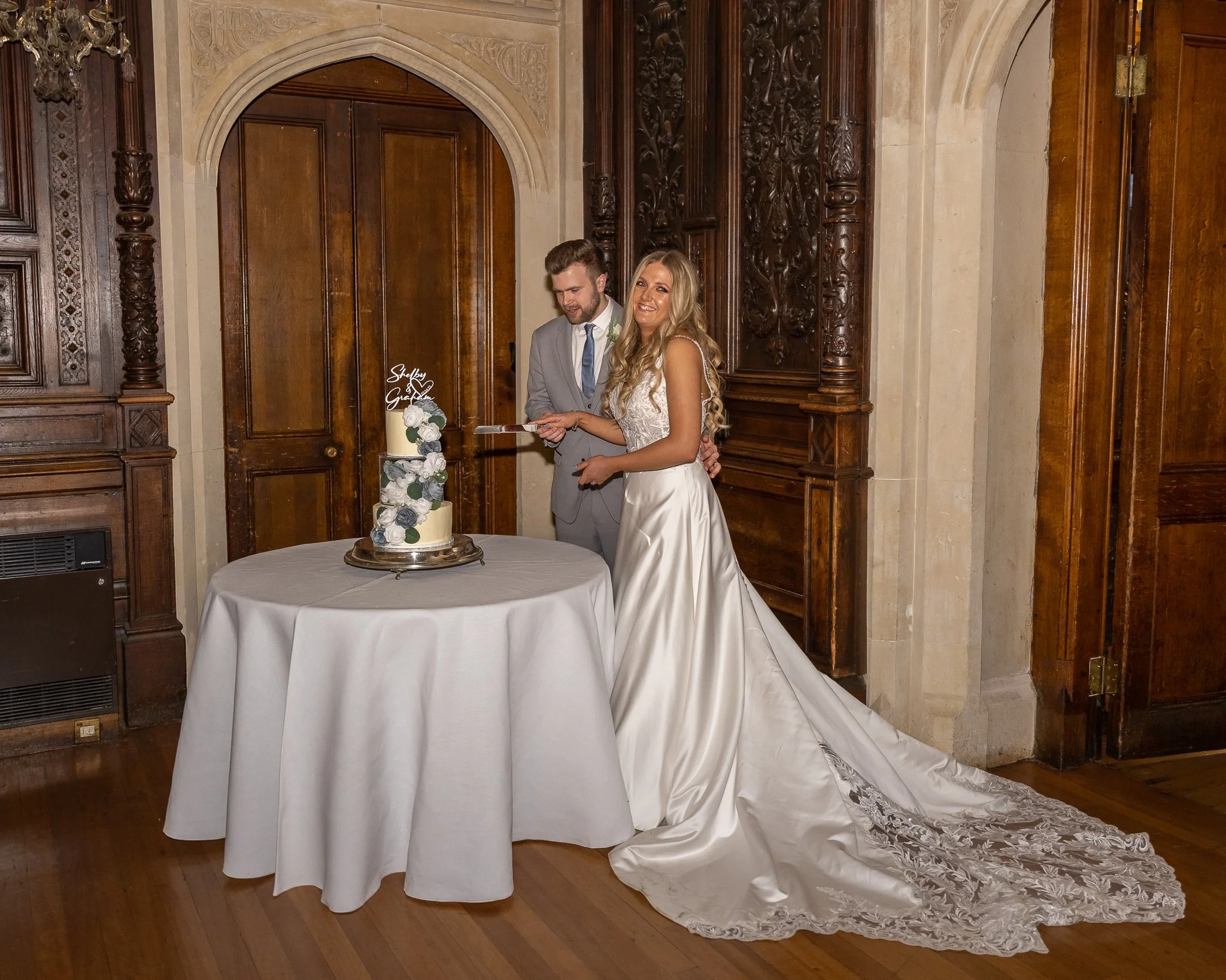 Dorset wedding photographer bride and groom cake cutting