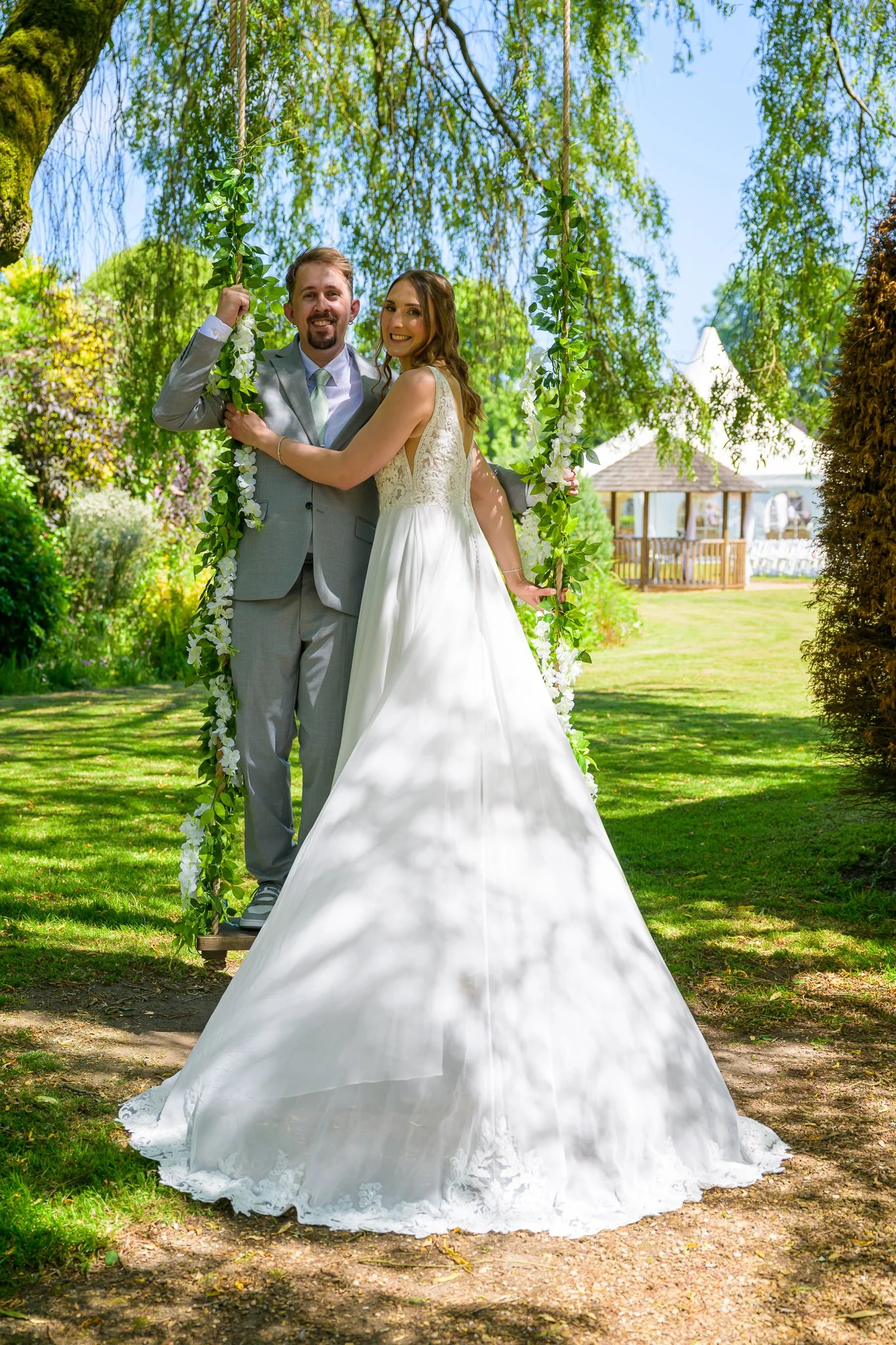 A bride and groom looking at and posing for the camera