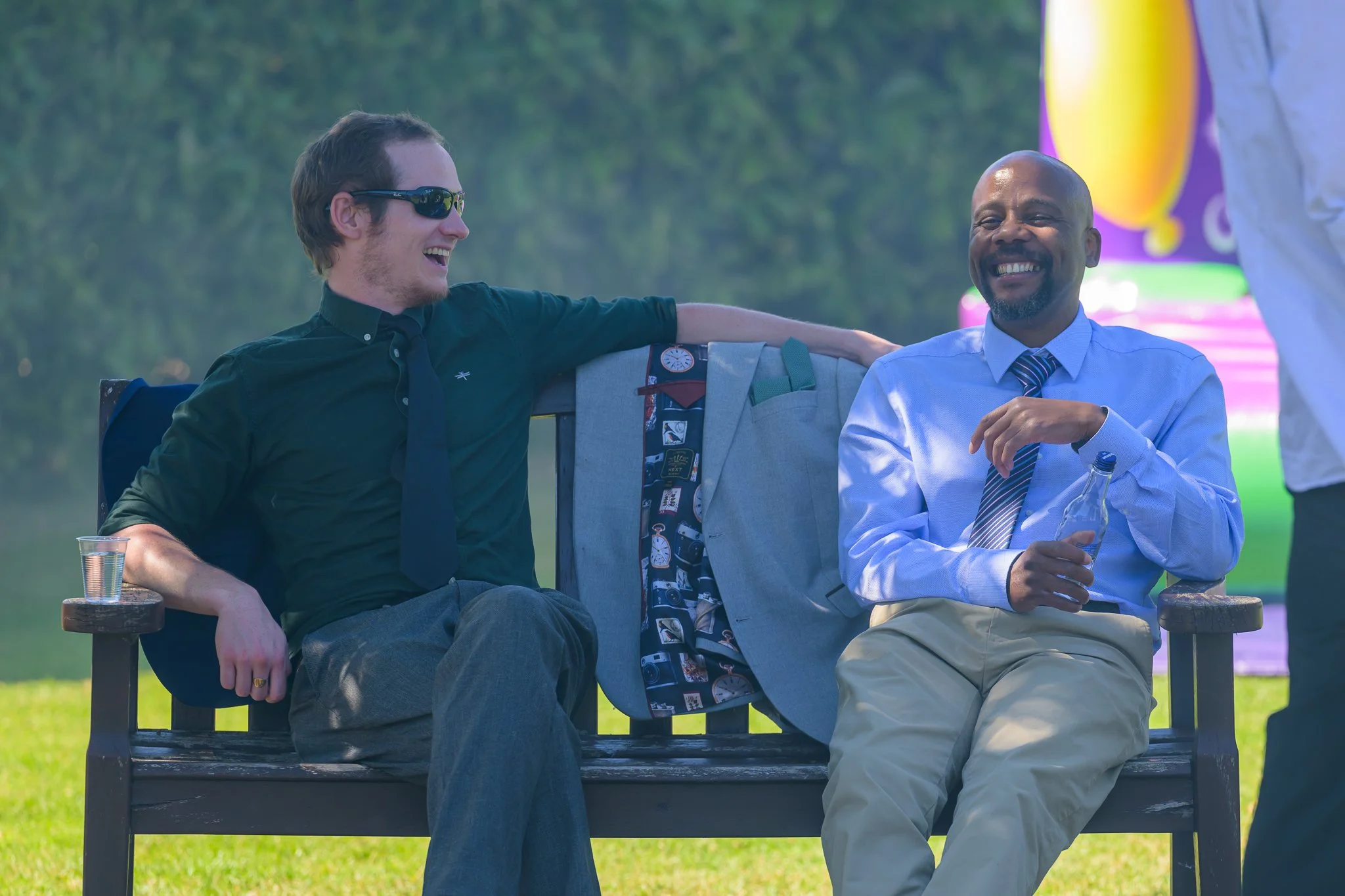 2 male wedding guests laughing