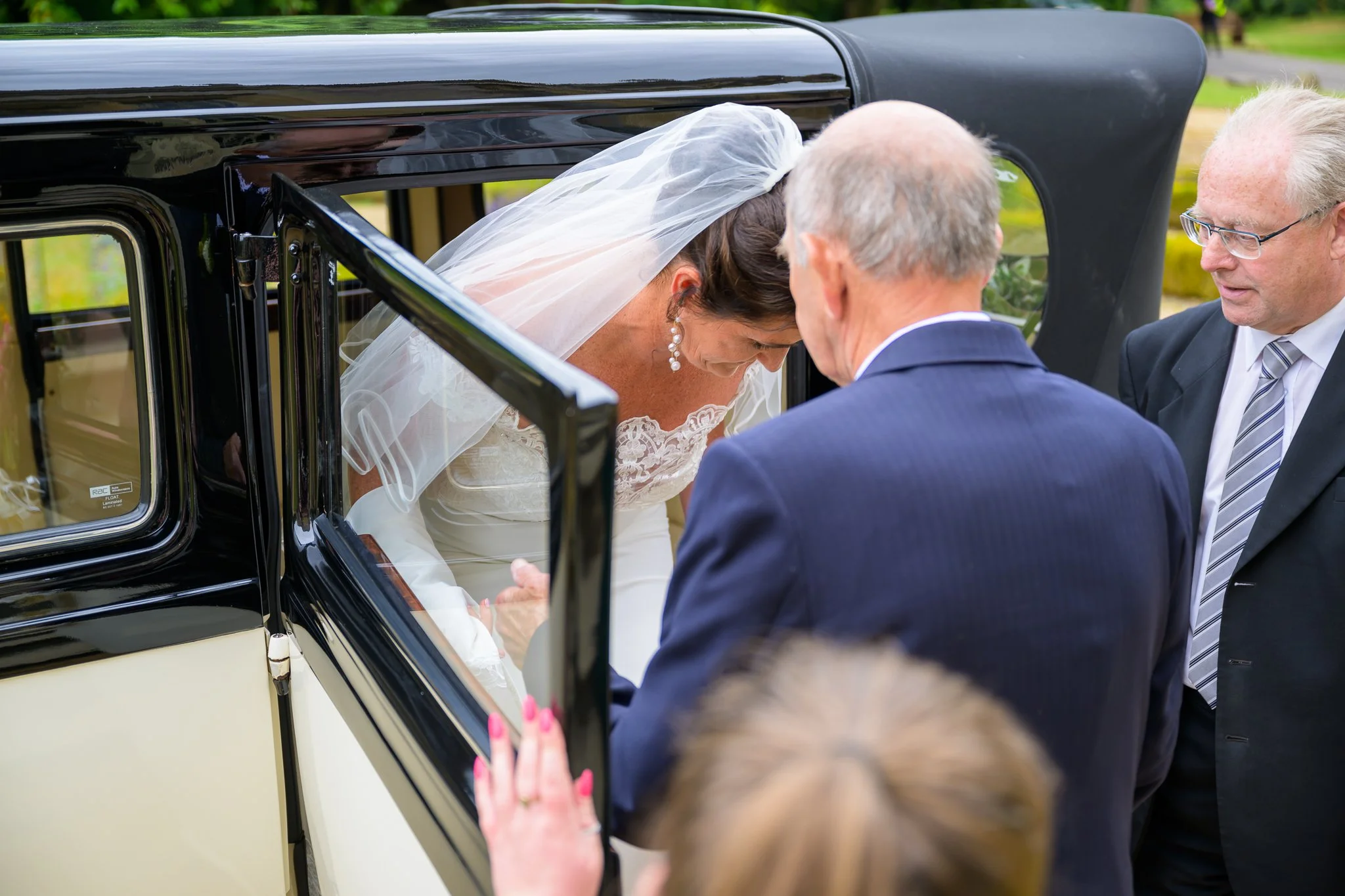 Bride and groom leaving the wedding car