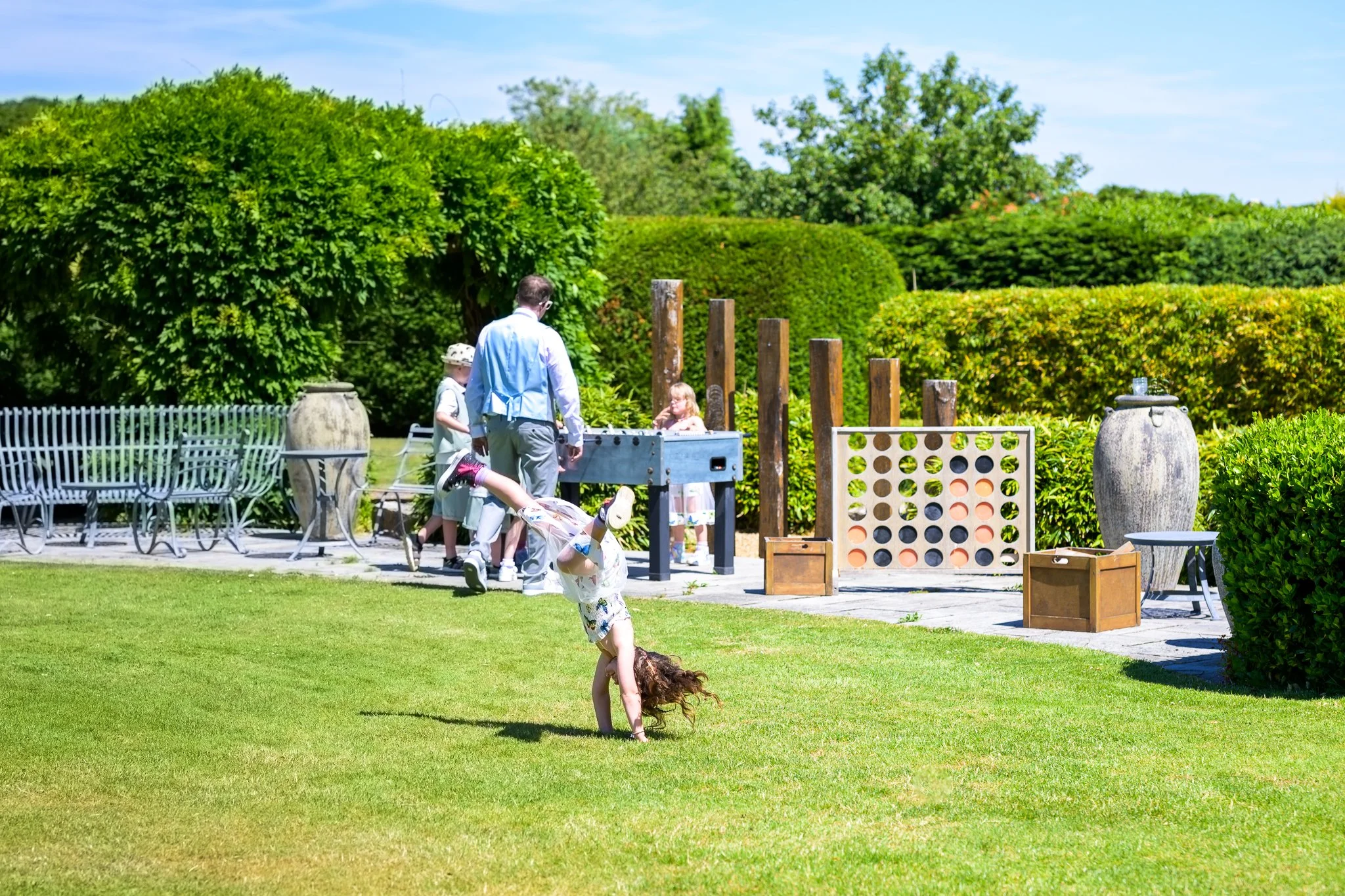Wedding guests playing on a field with lots of games and open space