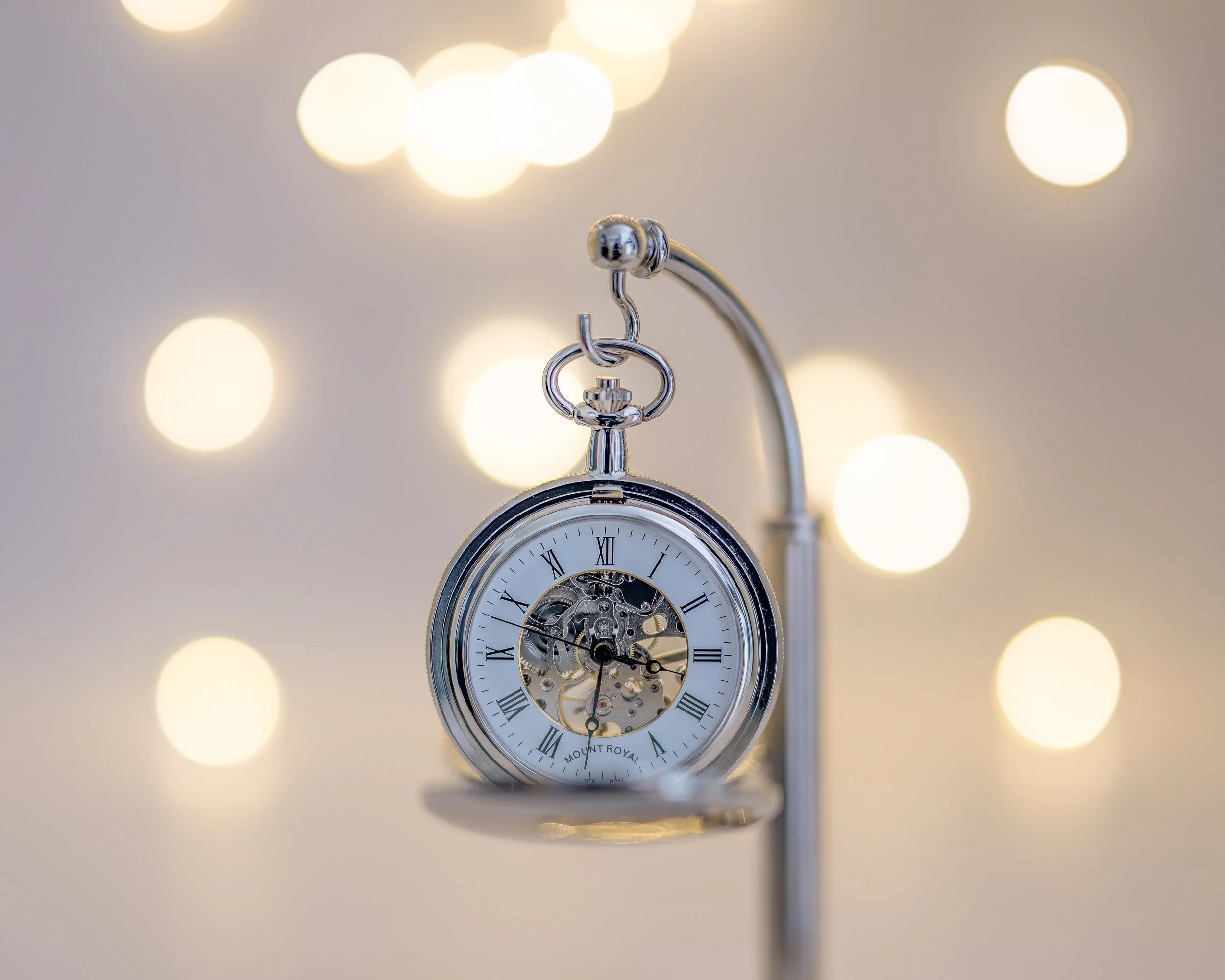 Beautiful product photography of a small clock with a sparkly background