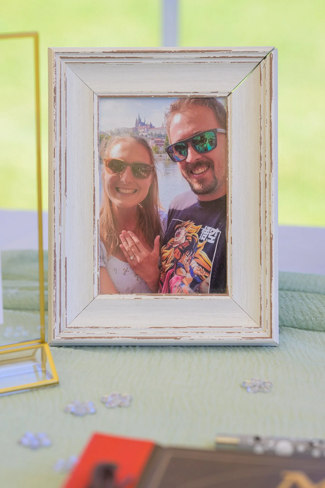 A picture frame of a bride and groom having fun in the past, taking a selfie