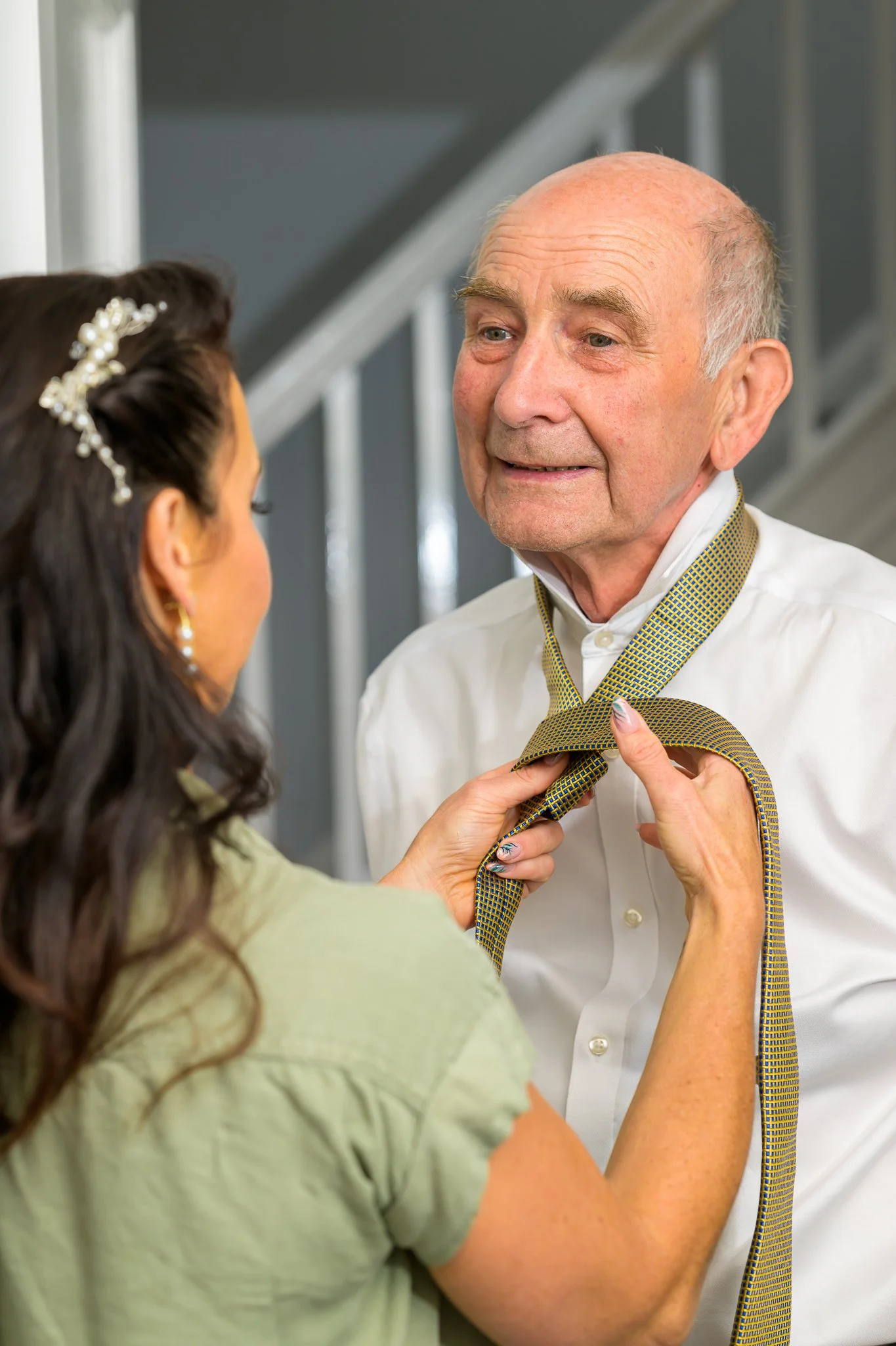 The groom getting his tie tied
