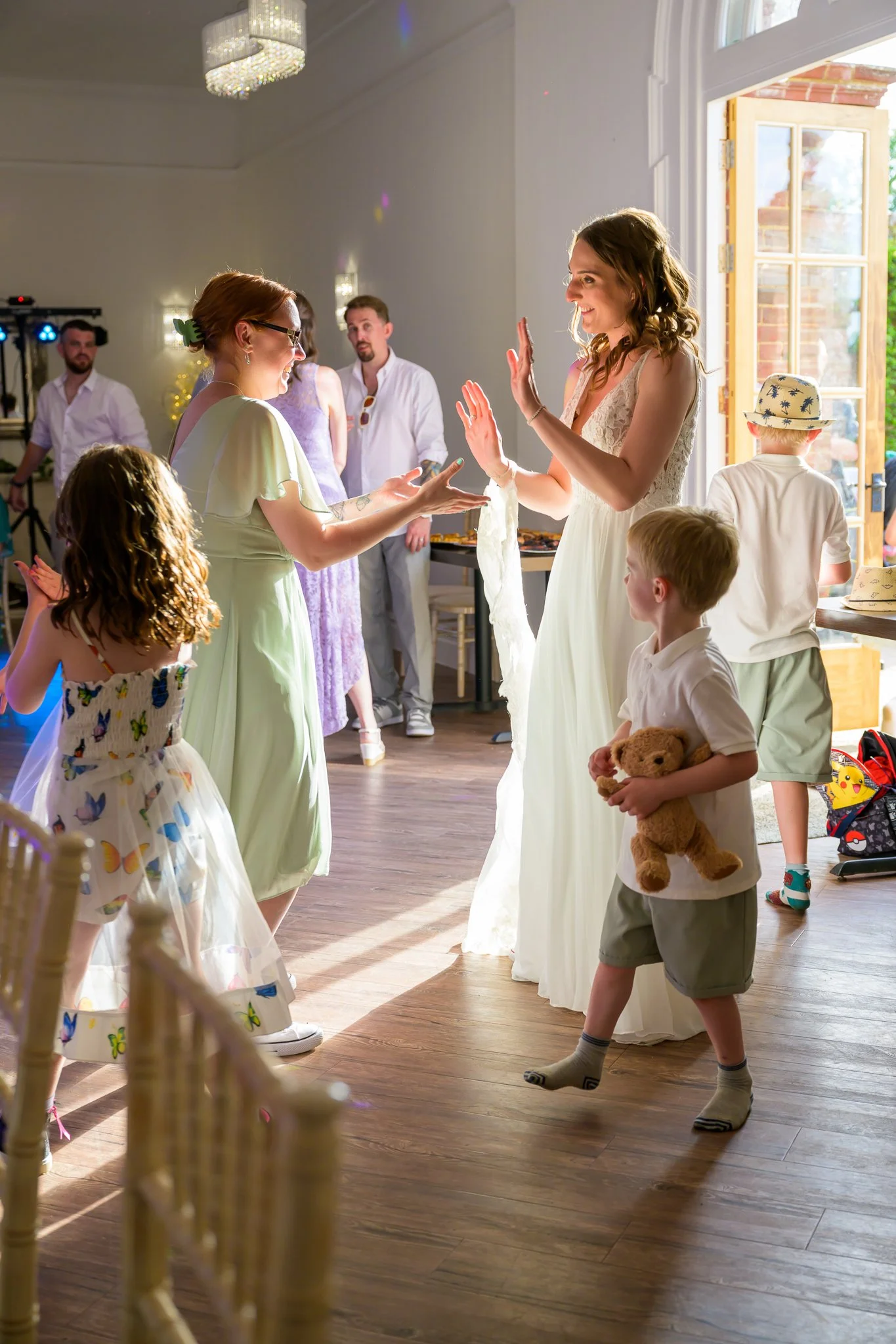 The groom and her guests dancing on the dance floor of their wedding venue