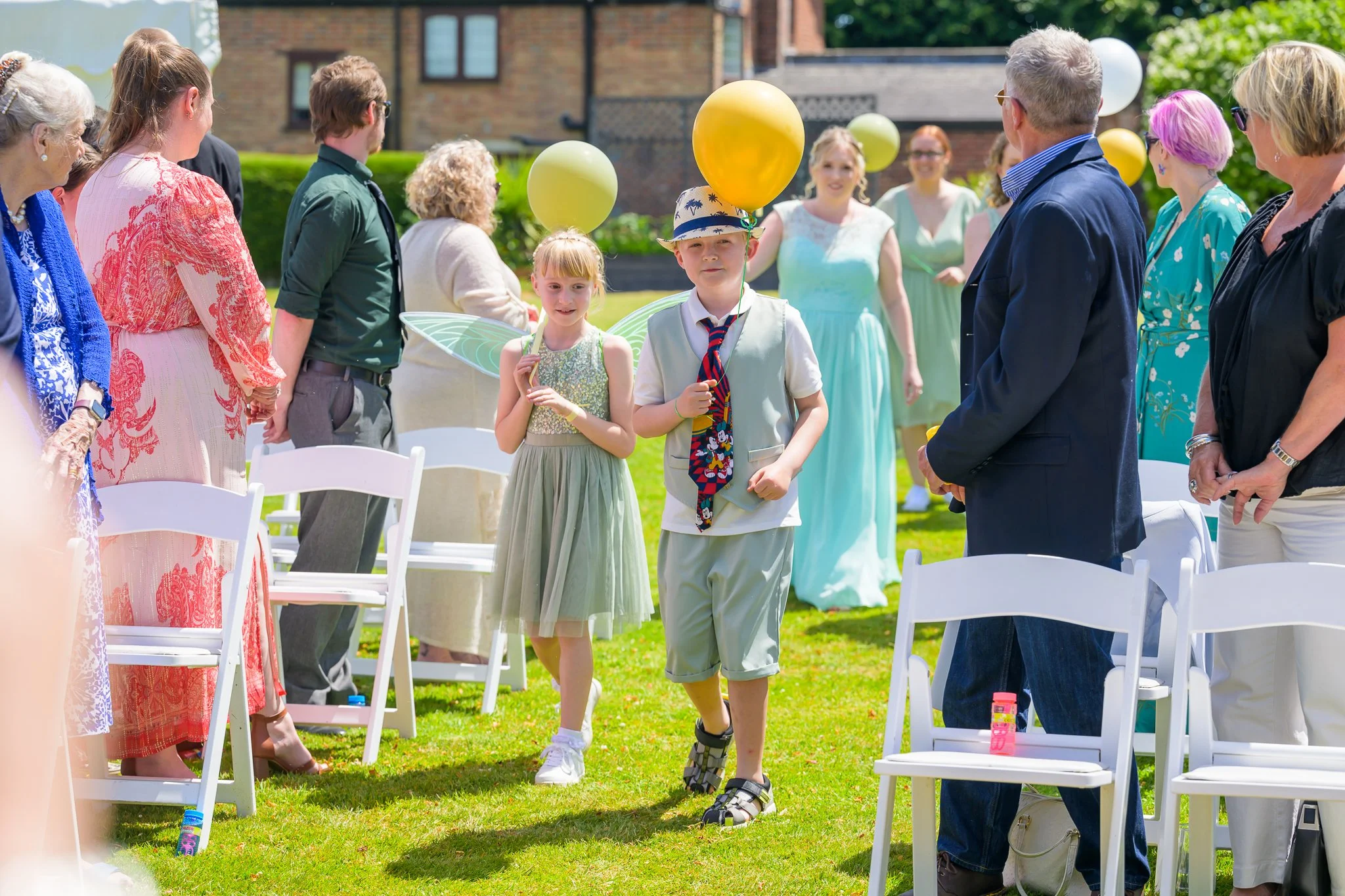 wedding guests lining up while waiting for the bride and groom to walk down the aisle