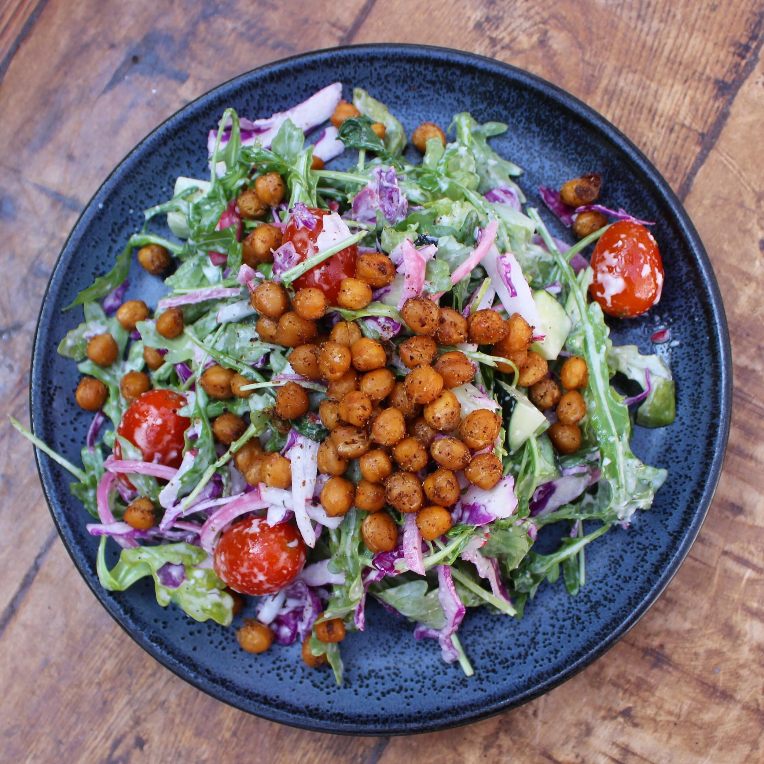 Our Spring Salad is here! The V&aring;rsalat is tossed arugula and red cabbage in a vegan dill aioli with radishes, oil cured tomatoes, cucumbers, &amp; spiced roasted chickpeas. It&rsquo;s vegan &amp; gluten free, or top it with any of our chef&rsqu