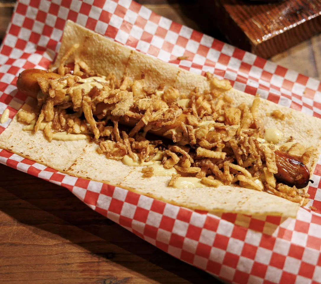 Happy National Hot Dog Day to all who celebrate. Grab a footlong Norse P&oslash;lse &amp; Pint for $20! Wrapped in potato lefse and topped with curry ketchup, IPA dijon, and fried onions with a side of fries or our cucumber salad 🌭

#seattlerestaura