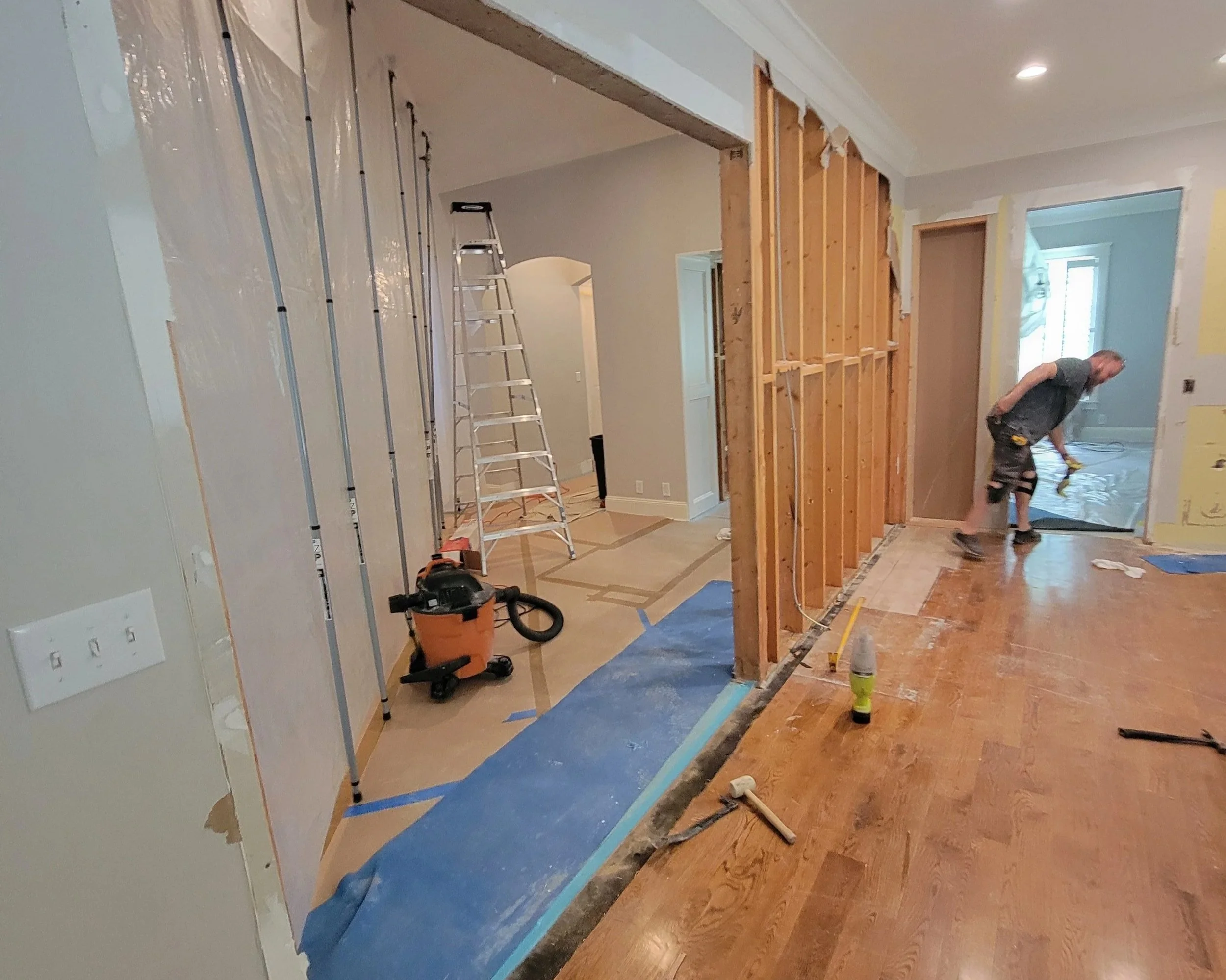 Removing a stud wall to open the area.