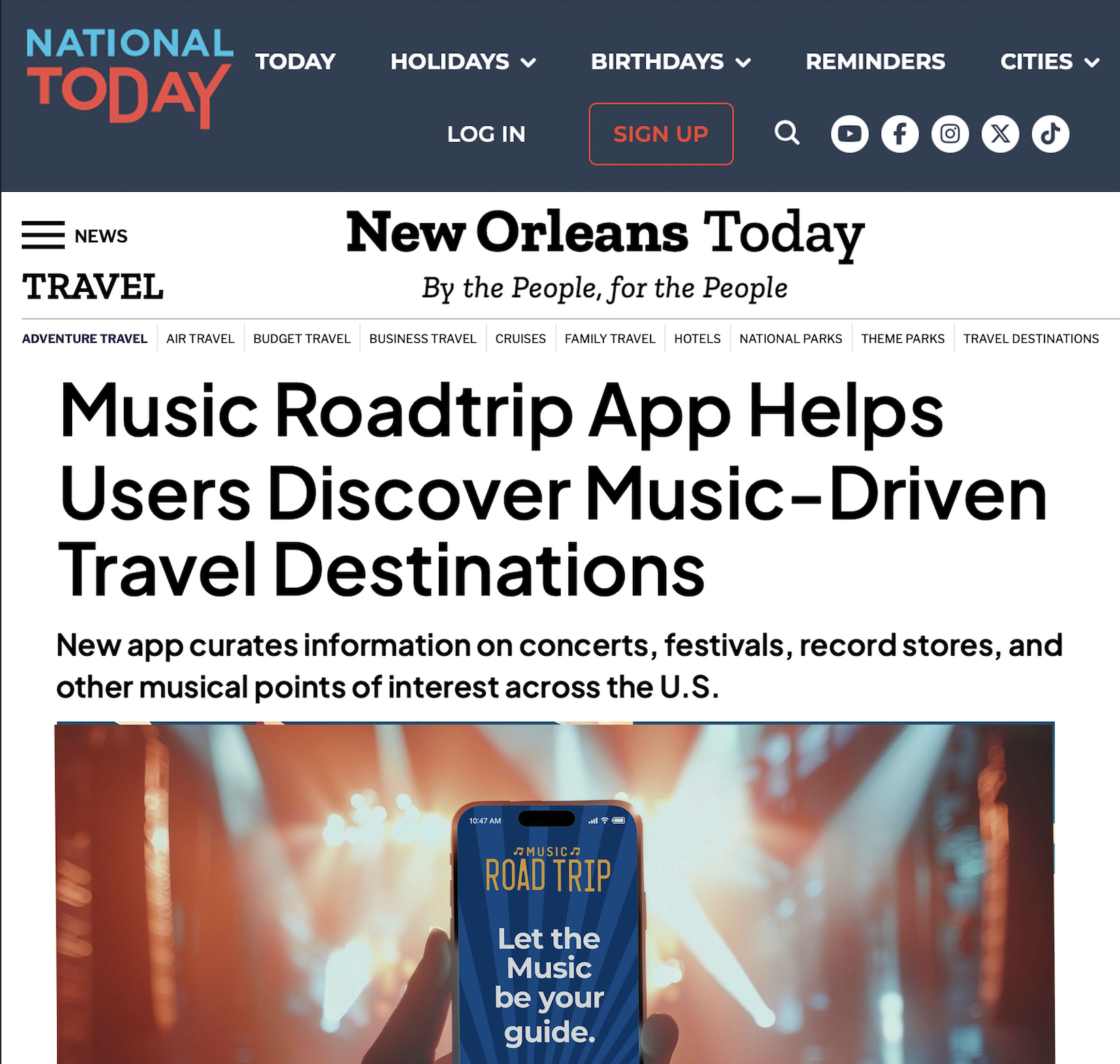 A smartphone displaying a music app called 'Music Road Trip' in front of a concert stage with stage lights.
