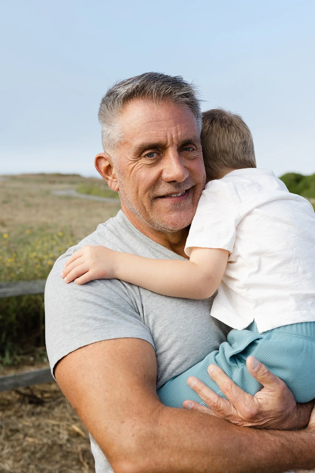 Grandfather holding young grandson during Bay Area family photo session