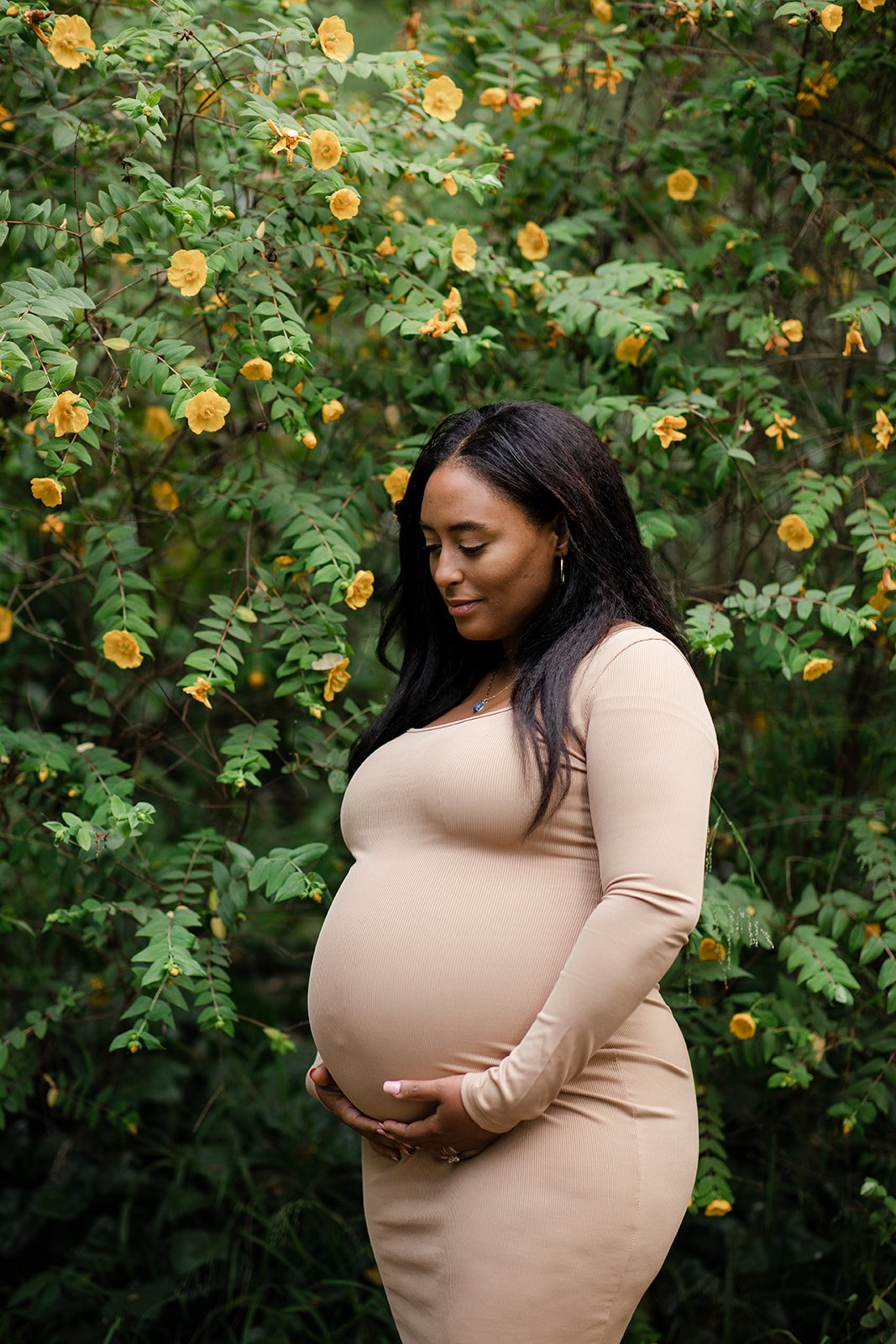 Expectant mother in contemplation, captured in a natural outdoor setting during her maternity photo session in Golden Gate Park