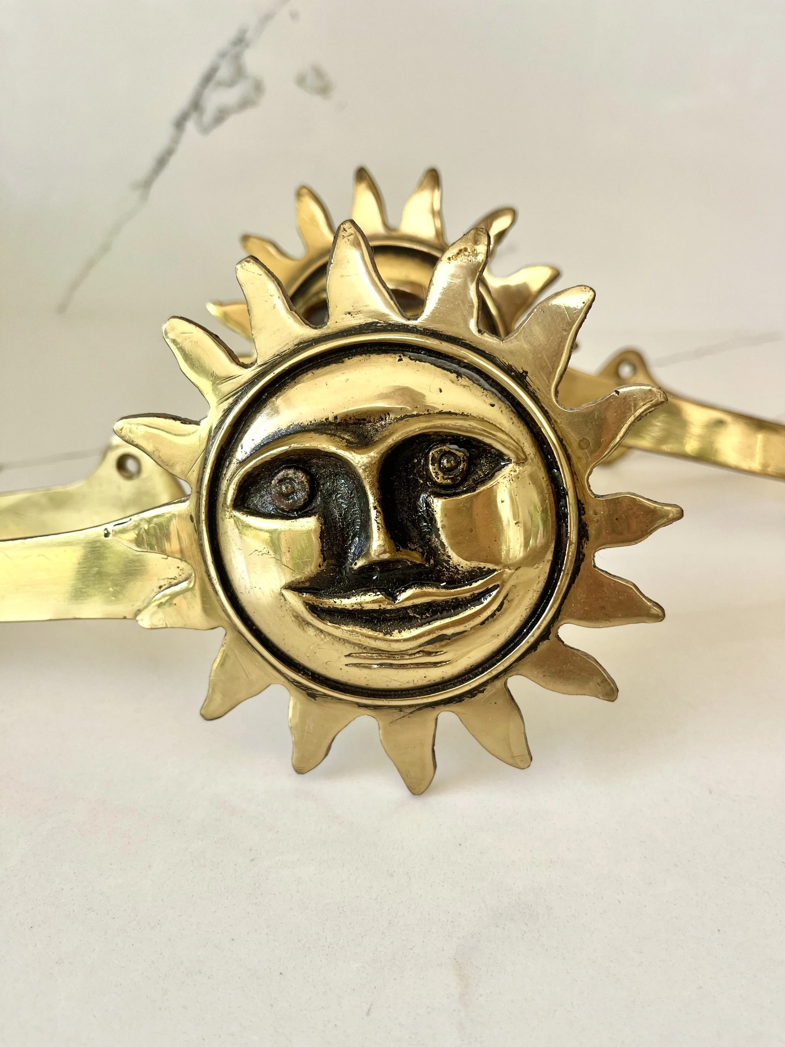 Pair of brass sun face curtain tie backs 1.jpeg