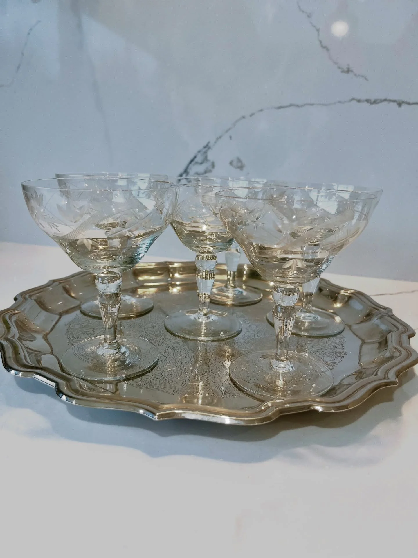 Set of six petite etched glass coupes and a silver plated piecrust edge serving tray. 
Sold separately 
&bull;
&bull;
&bull;
&bull;
&bull;
#homeentertaining #christmasdrinks #hosting #newyearseveparty #theartofhosting #vintagecoupes #silverware