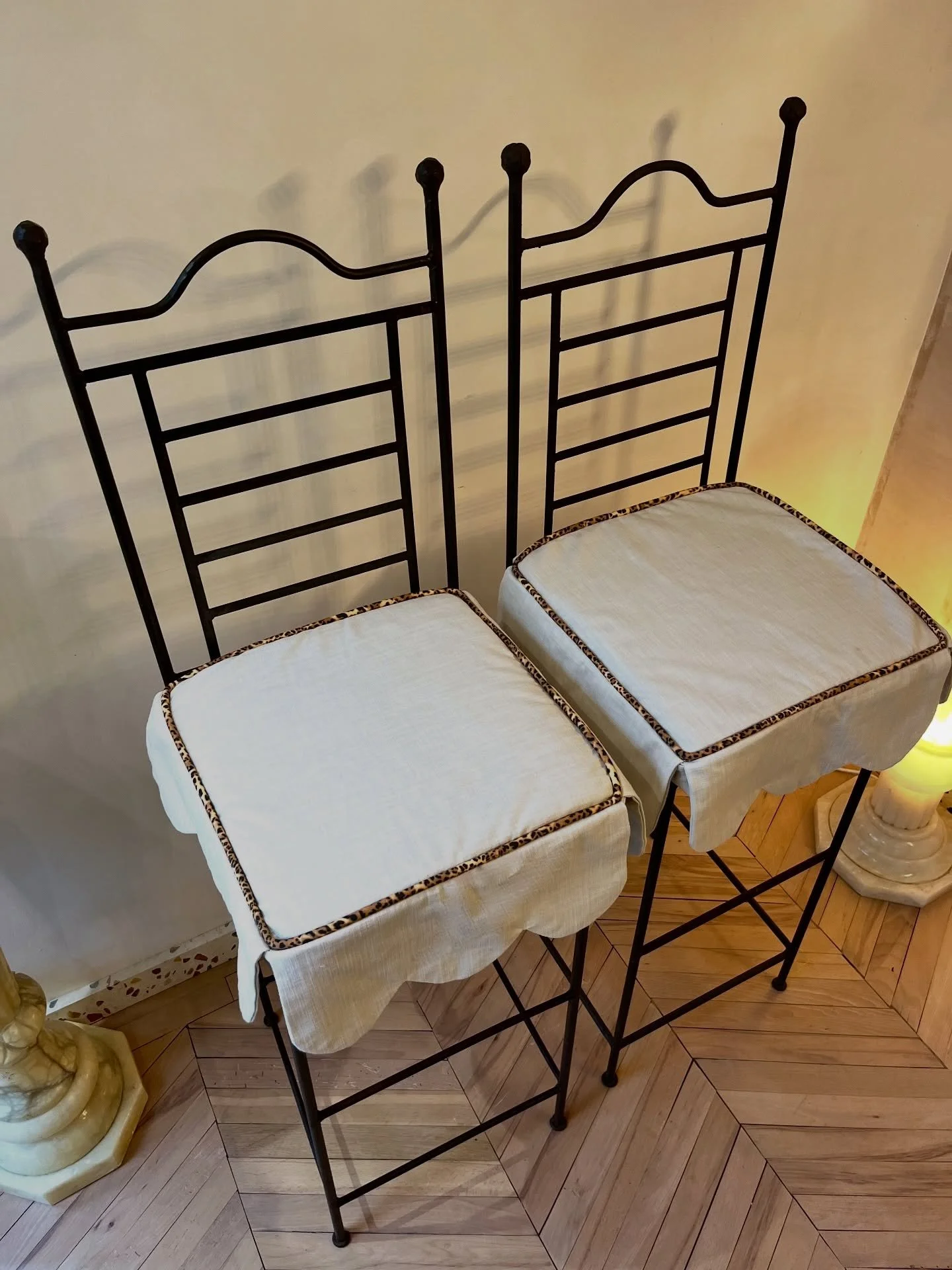 Pair of Cast Iron Tall Stools With Scalloped Cushions 
Extremely heavy cast iron pair of tall stools, perfect for inside or out. These are definitely statement pieces!

The scallop cushions with leopard print piping are new and the inner cushions can