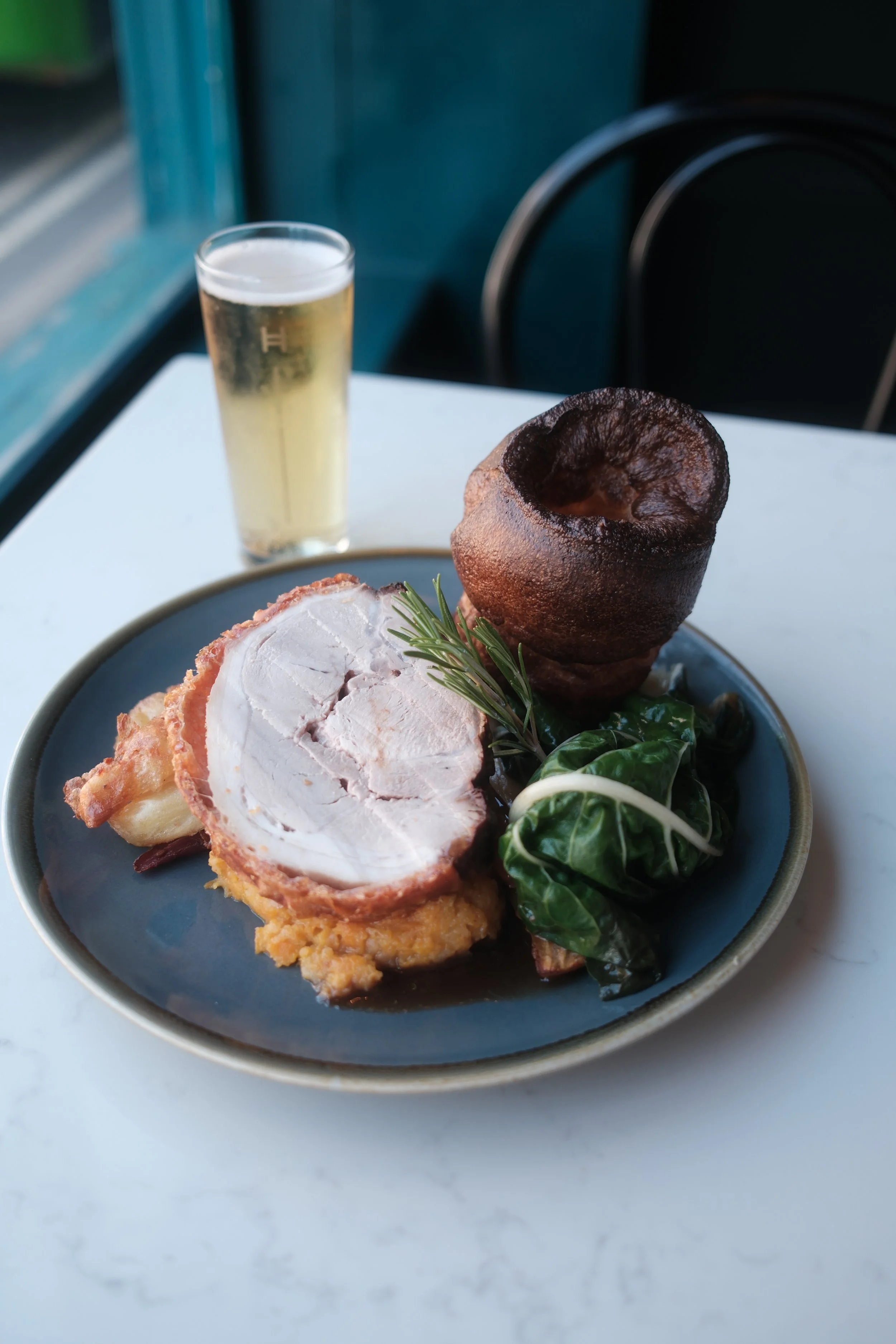 Sunday roast pork, served at Five Little Pigs, featuring locally sourced and seasonal ingredients