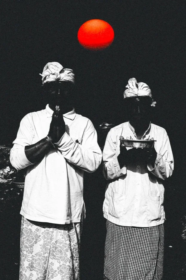 Deux personnes en vêtements traditionnels indiens, portant des turbans, avec un ciel sombre et un soleil rouge en arrière-plan.