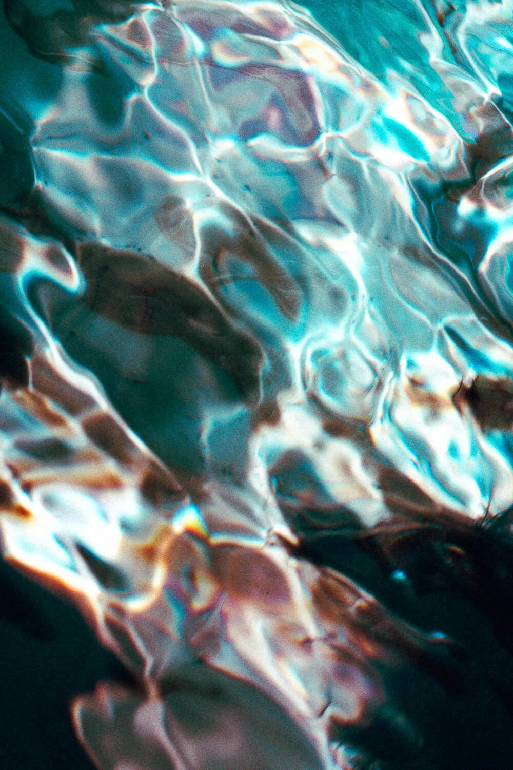 Close-up of crumpled metallic foil reflecting colorful light